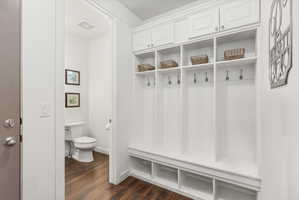 Custom built-in mudroom cabinetry with upper storage, individual cubbies, and lower shelving