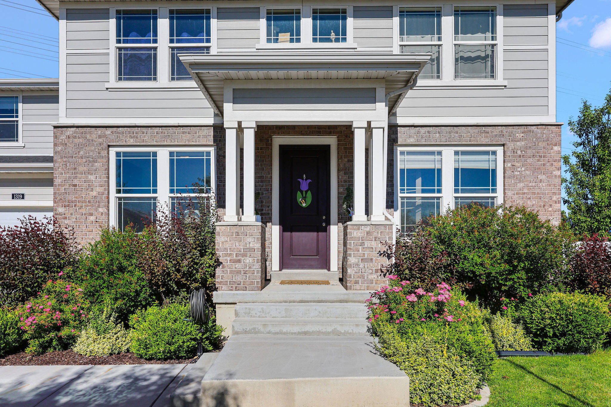 Brick and siding exterior featuring a covered entry
