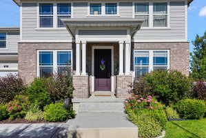 Brick and siding exterior featuring a covered entry