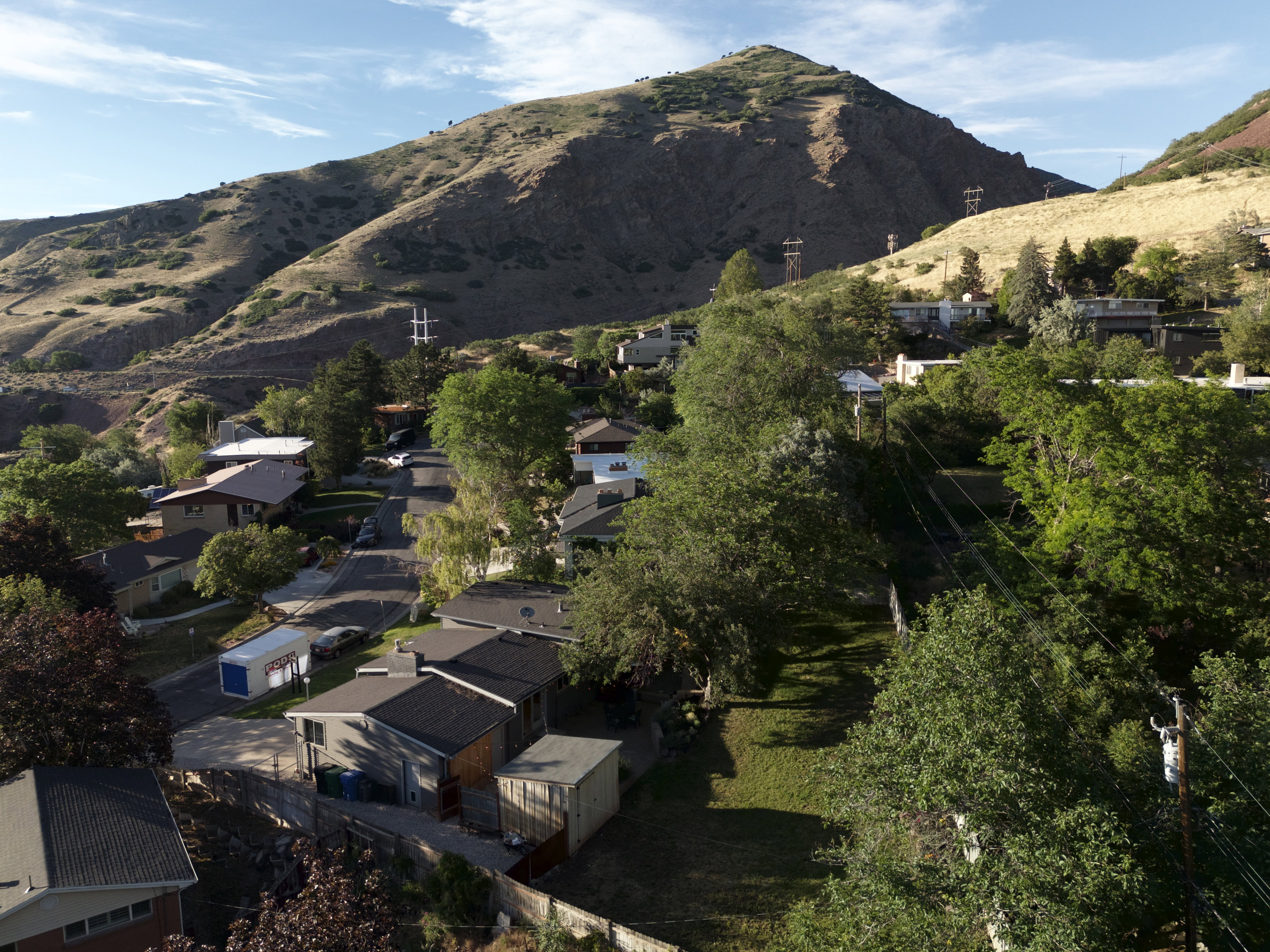 Mountainous landscape framing a residential neighborhood with mature trees
