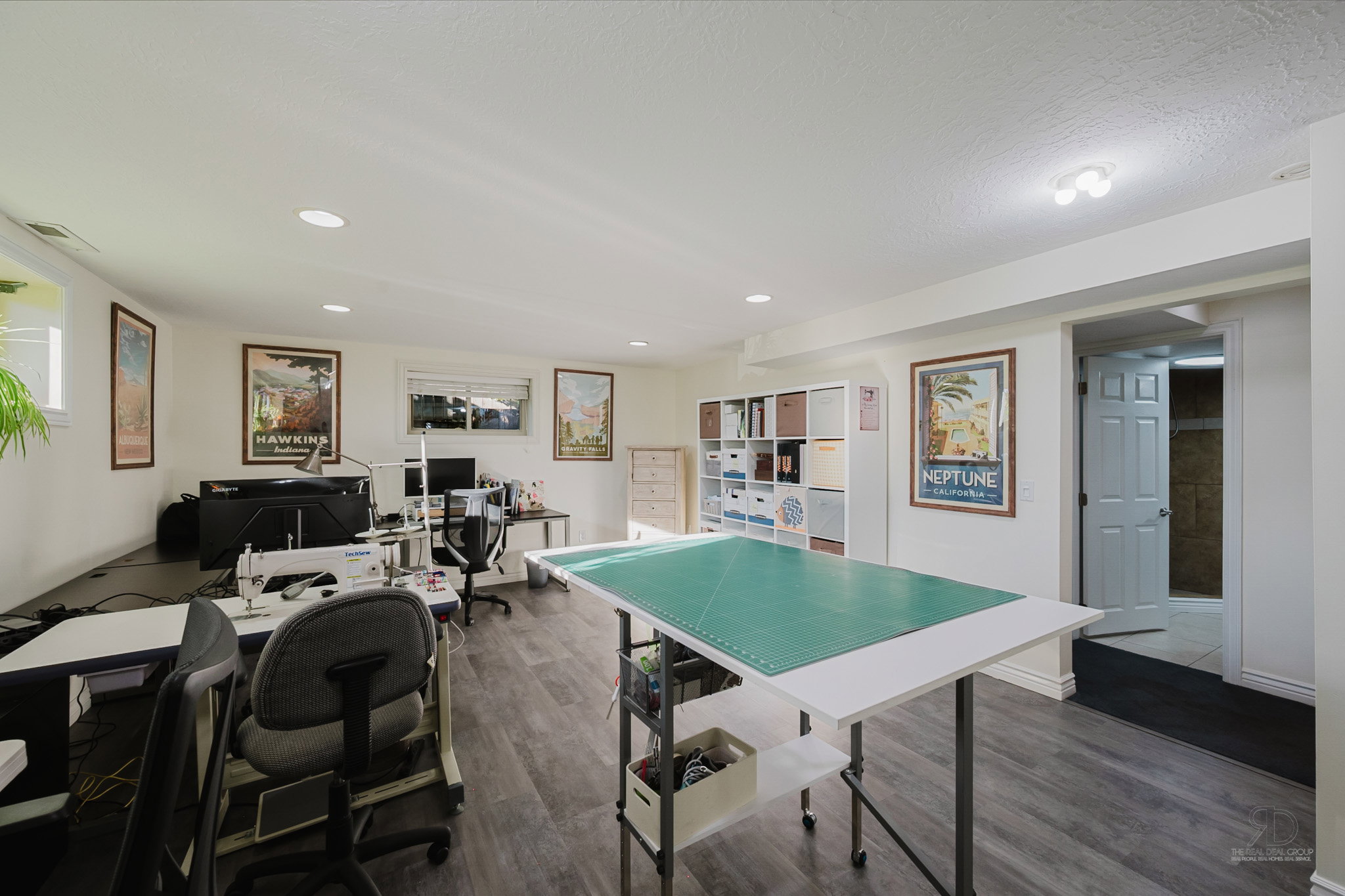 Spacious room featuring wood-finish flooring, recessed lighting, and multiple windows