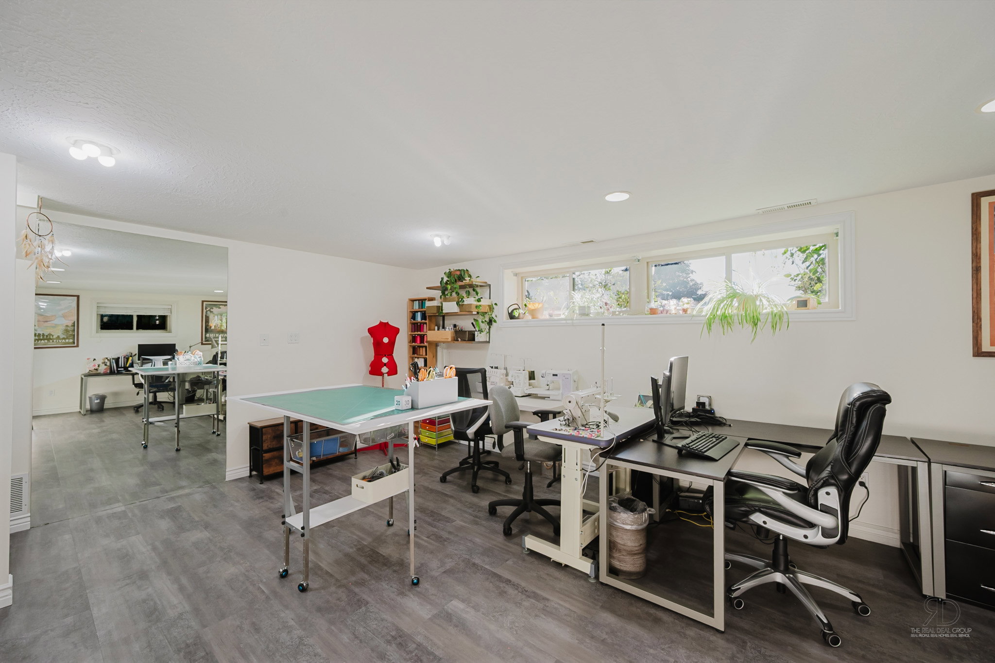 Spacious room featuring wood-finish flooring, recessed lighting, and multiple windows