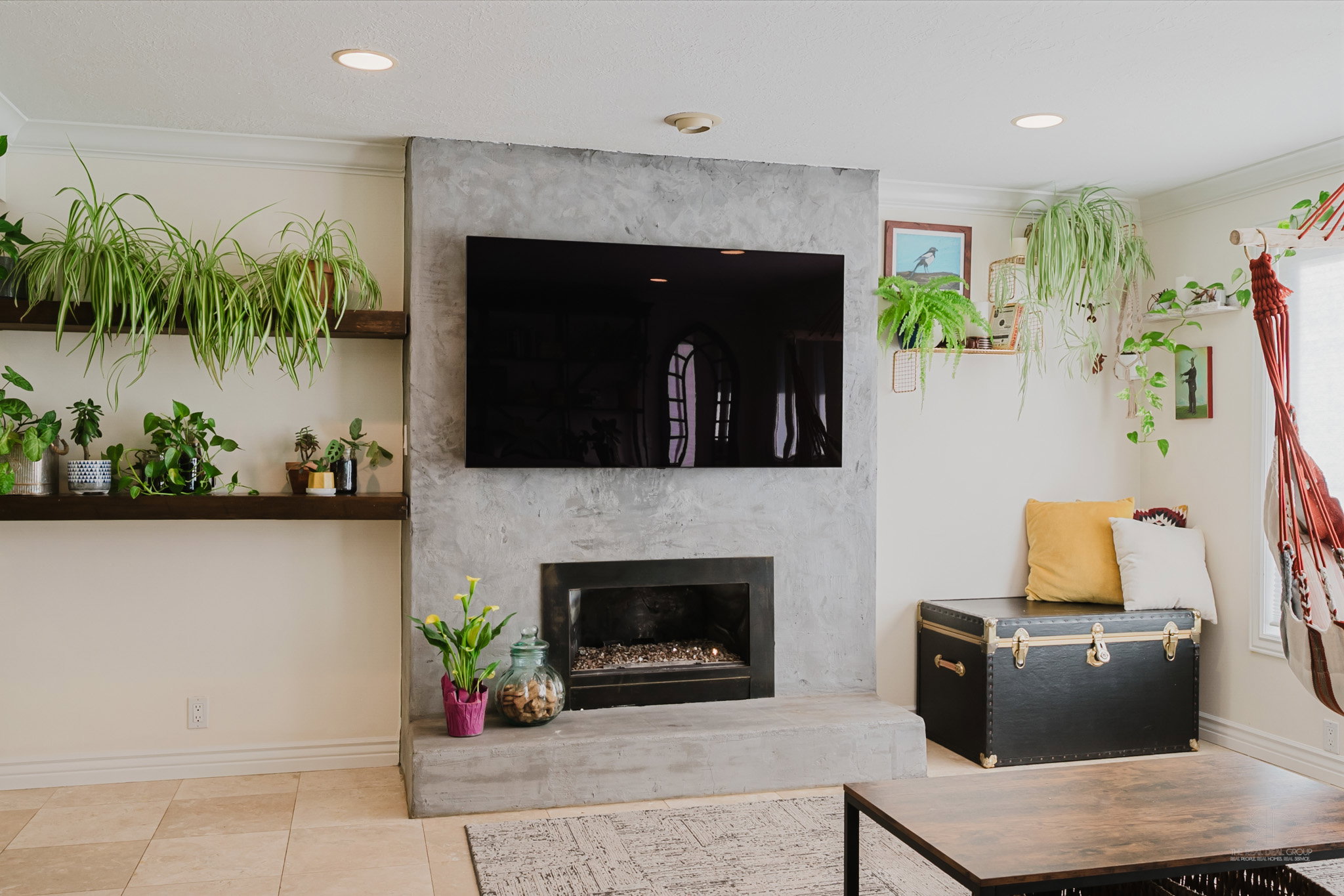 Concrete-finish fireplace surround with an integrated firebox and hearth