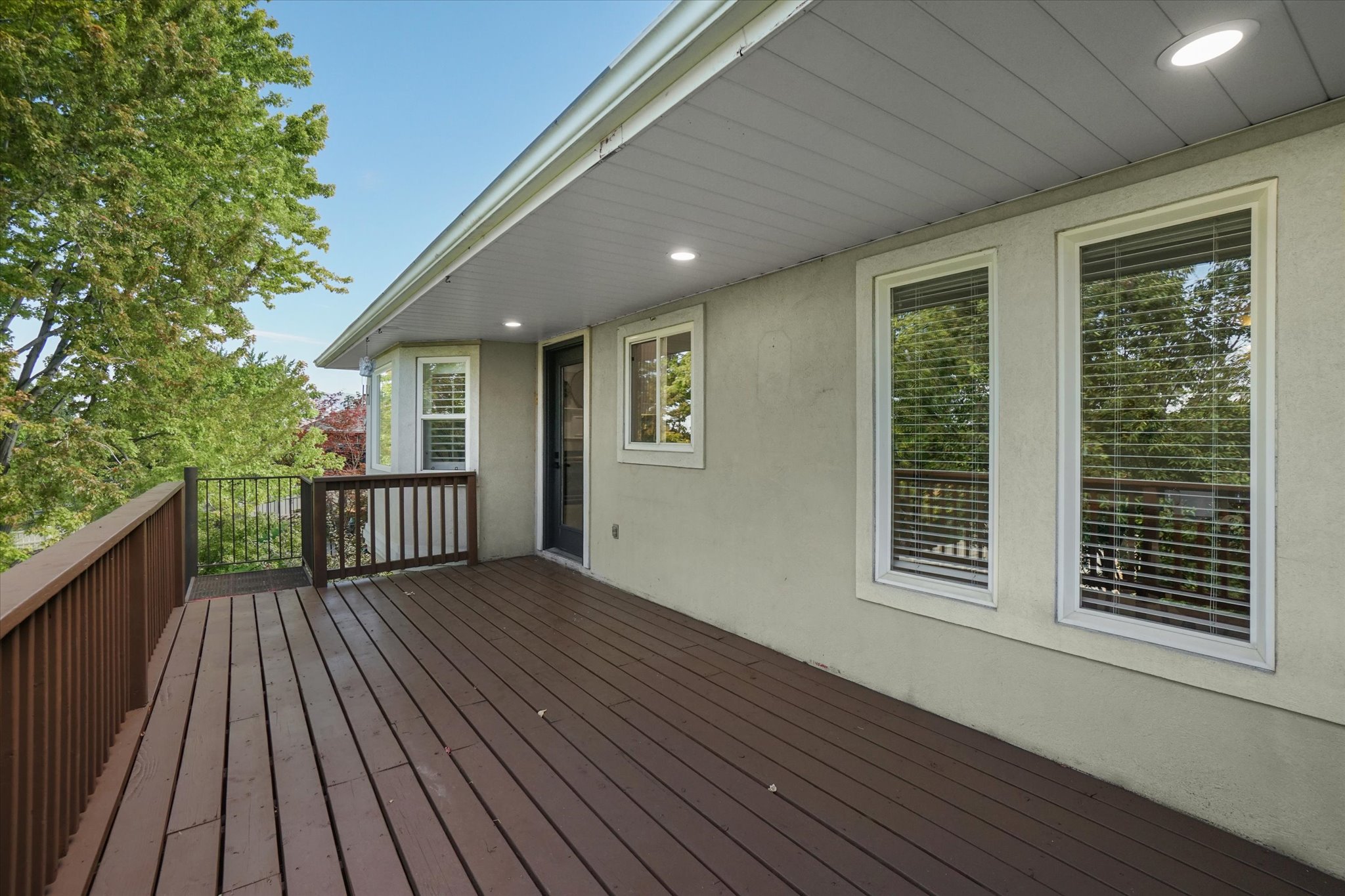 Spacious wood-finish deck with dark brown railing