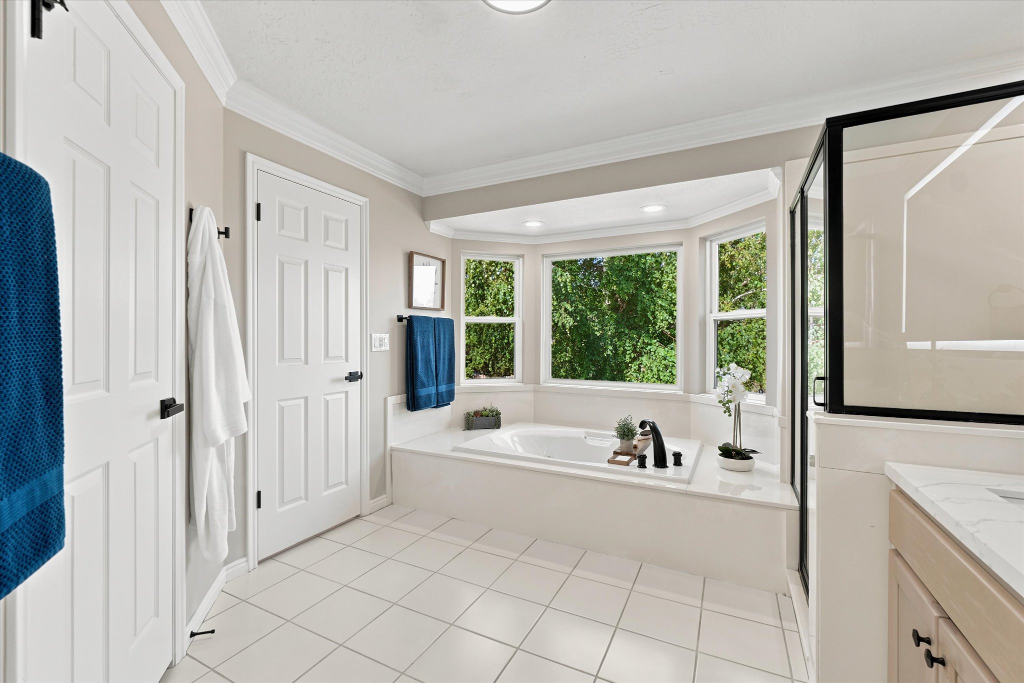 Bathroom featuring a built-in soaking tub with a bay window surround