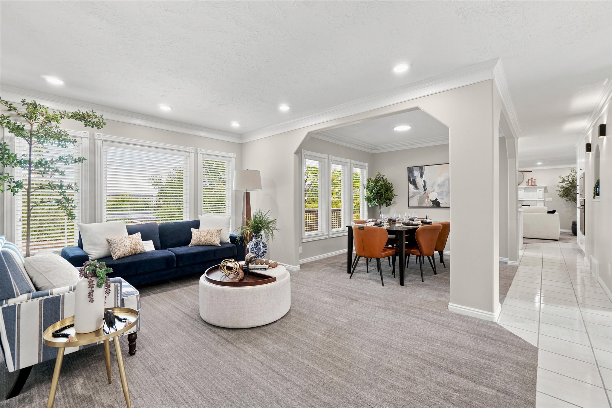 Spacious common area featuring recessed lighting, extensive crown molding, and large window banks.