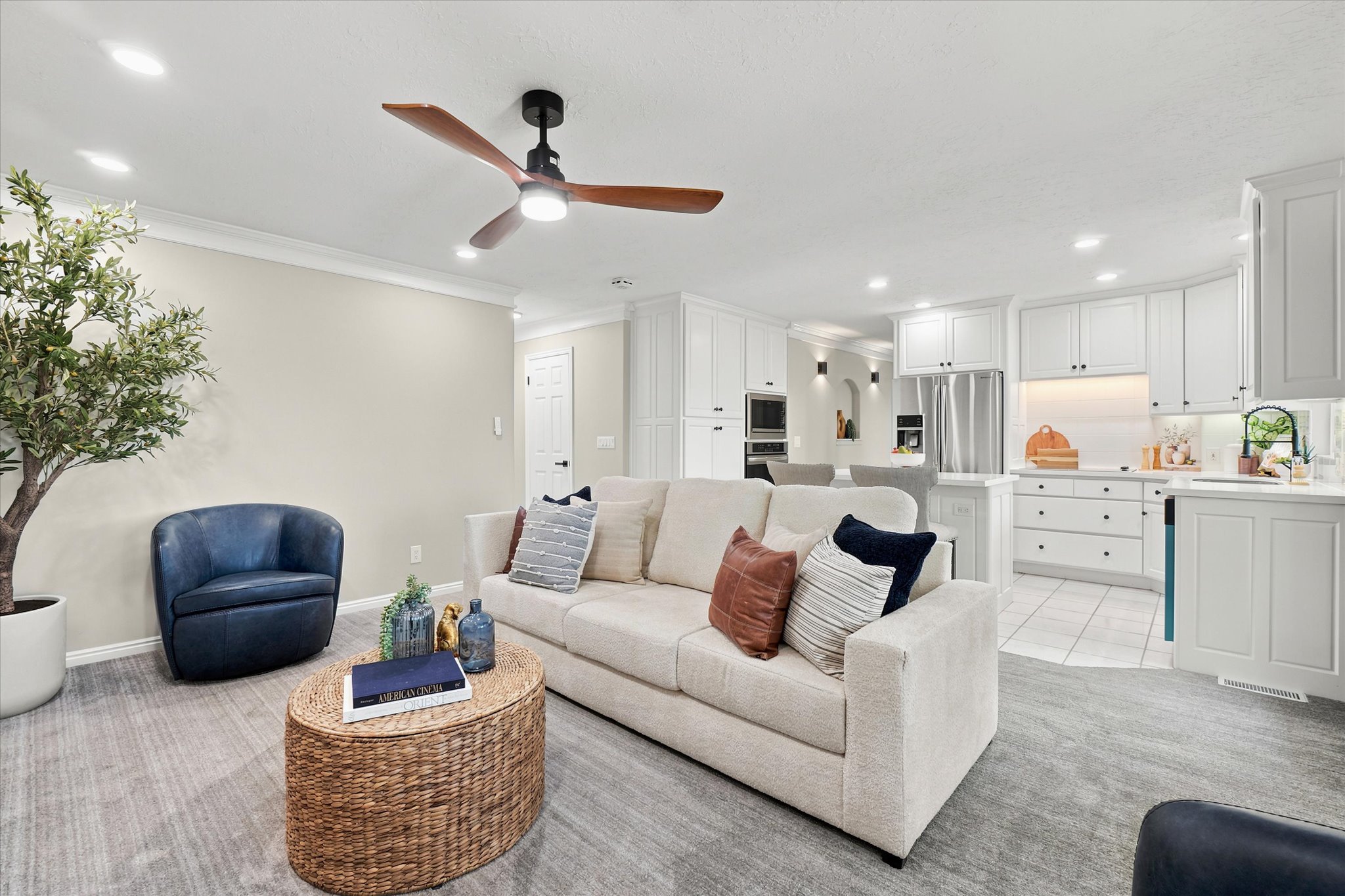 Open-concept living space with recessed lighting and a wood-finish ceiling fan