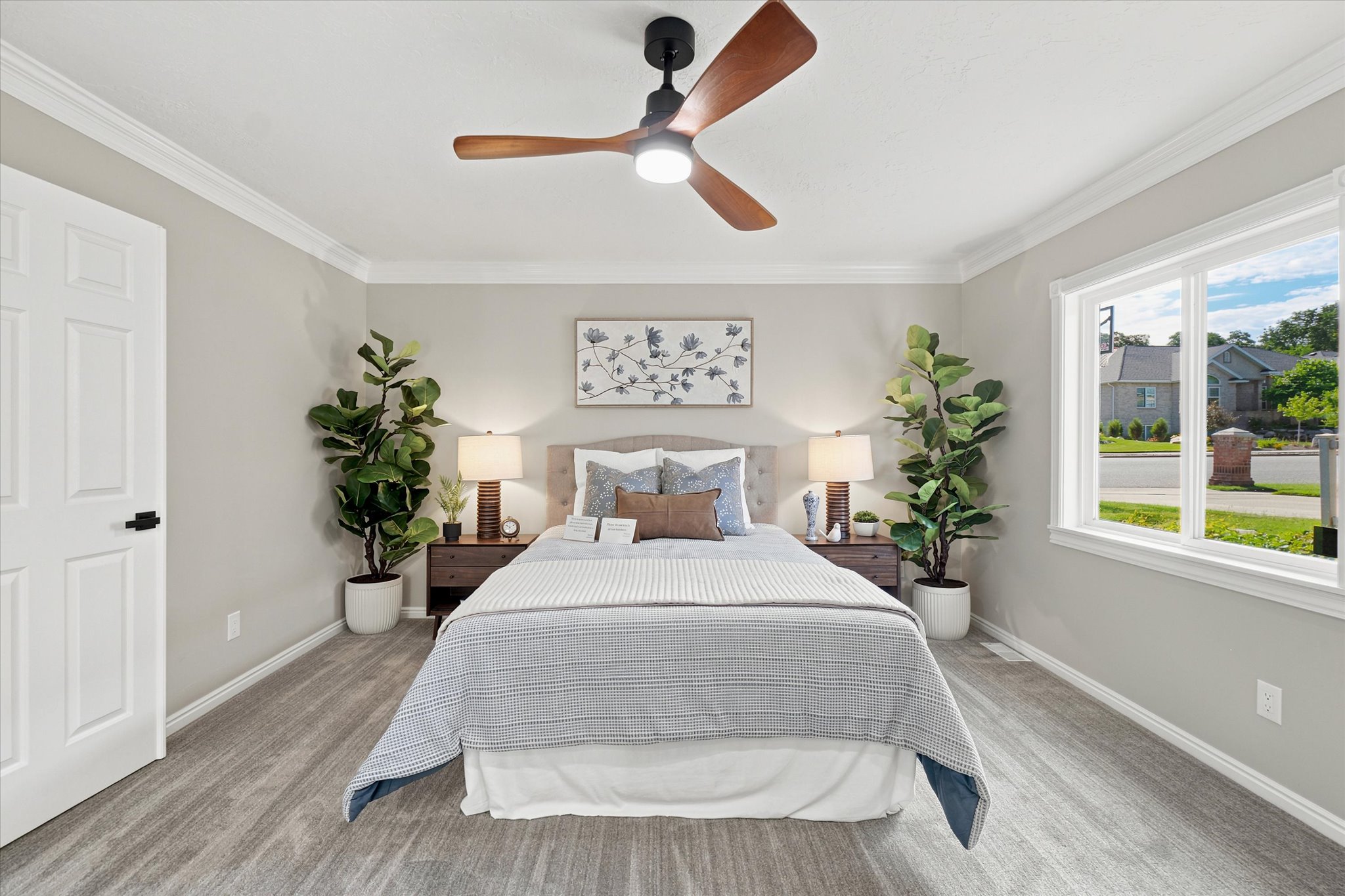 Bedroom featuring wood-finish flooring, a contemporary ceiling fan, and crown molding