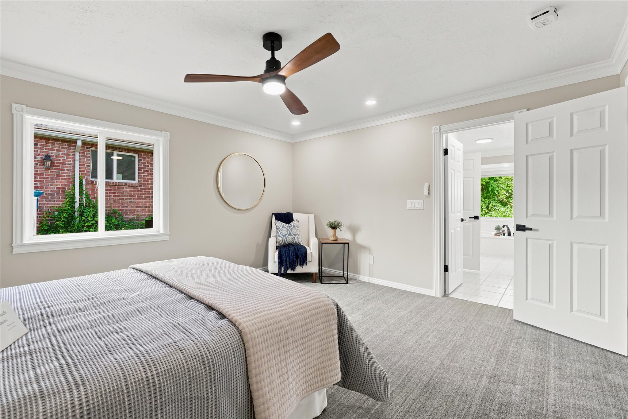 Bedroom featuring a contemporary ceiling fan with integrated lighting, recessed lighting, and a window with white trim