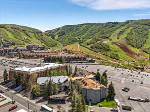 Expansive property featuring multiple buildings, surface parking areas, and mature evergreen trees