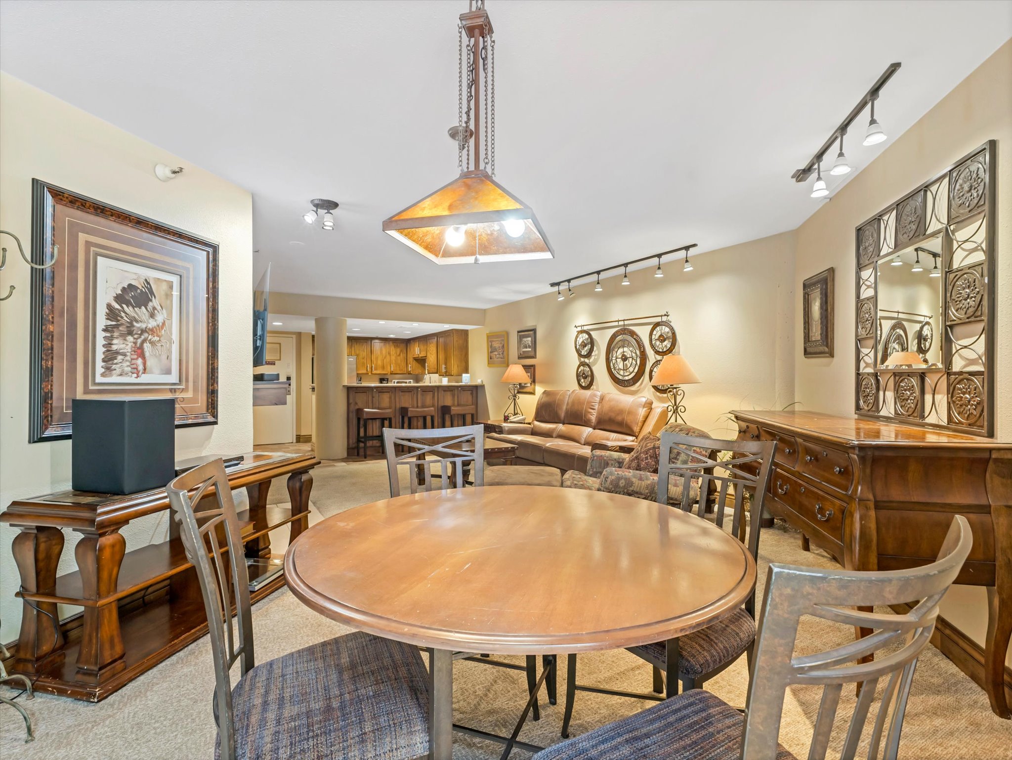 Dining area with a central round table and track lighting