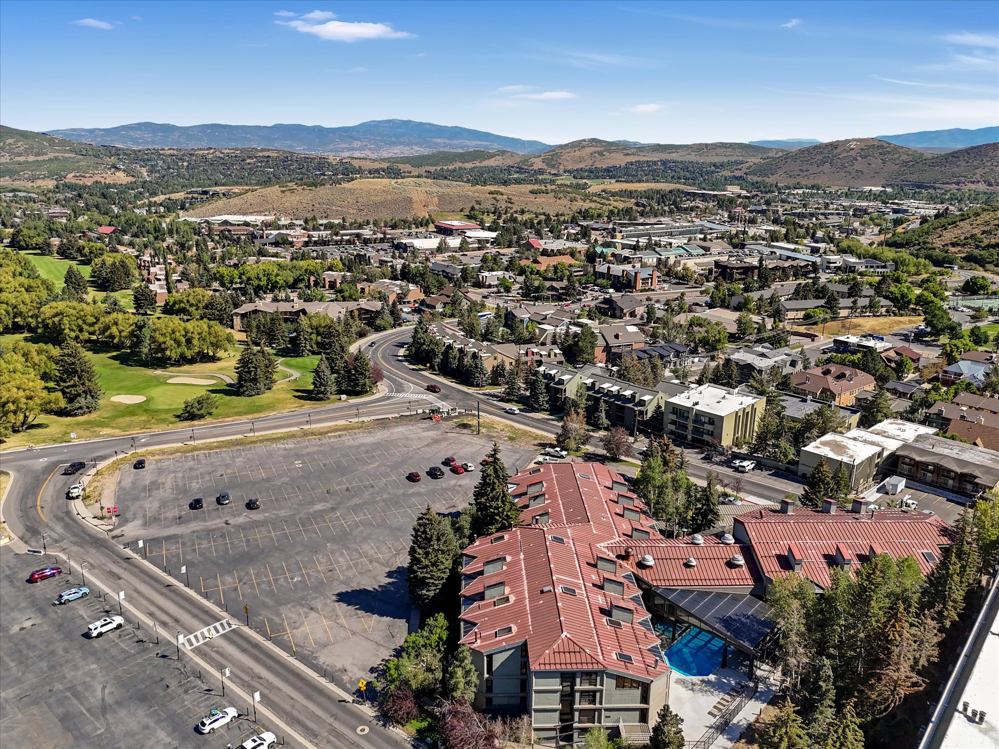 Expansive mountain community setting featuring residential structures, commercial areas, and a golf course
