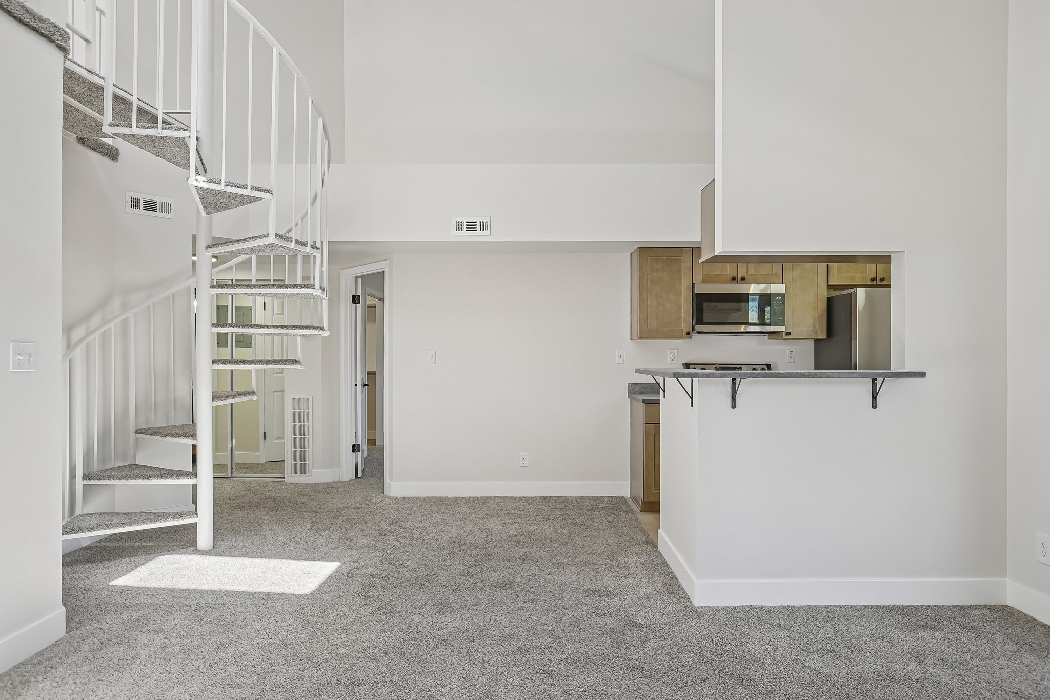 Modern spiral staircase with carpeted treads