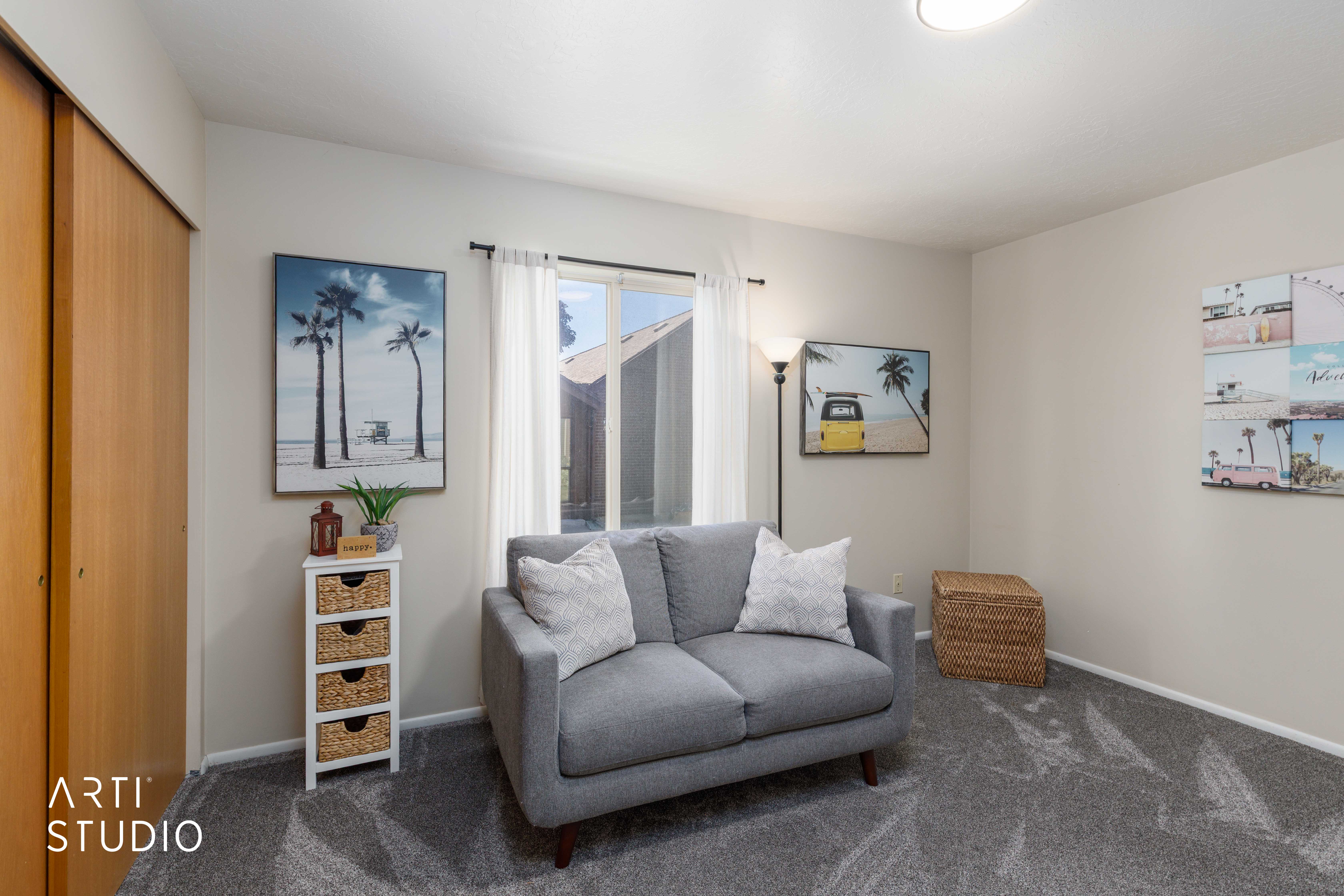 Sliding closet doors with wood-finish panels, light gray walls, and dark patterned carpeting