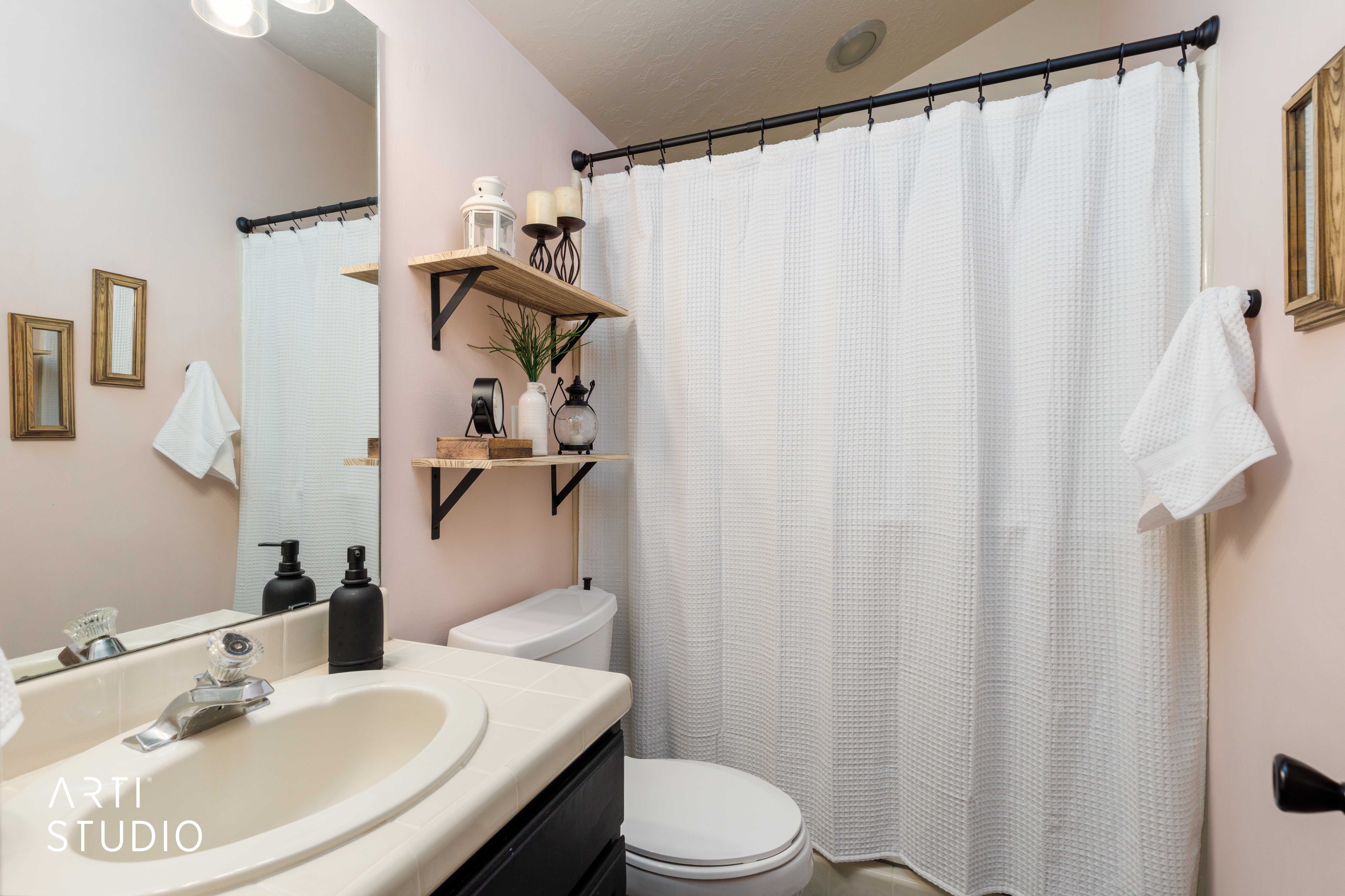 Bathroom featuring a vanity with an integrated sink, a mirror, and overhead lighting