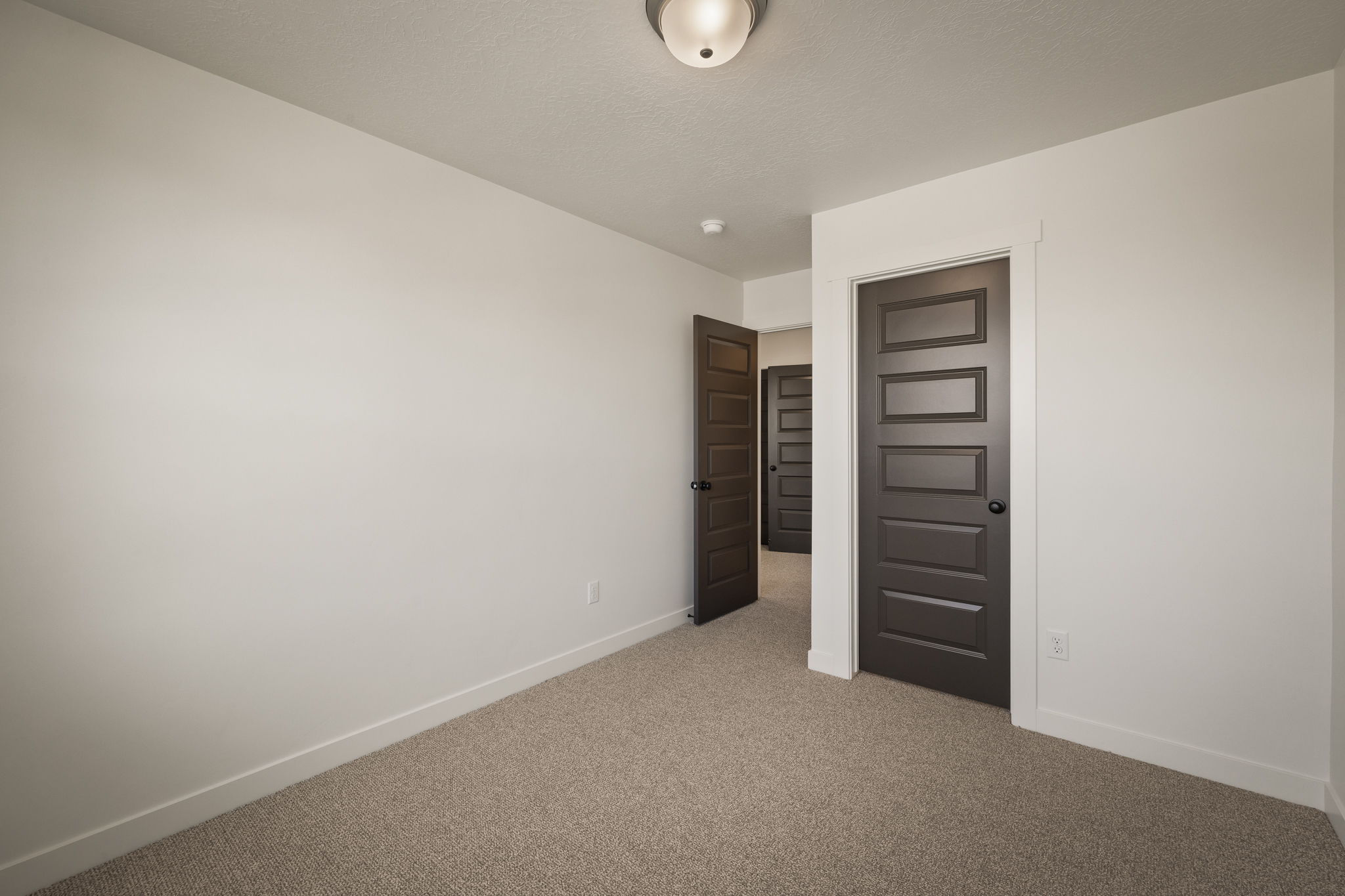 Neutral tone carpeting complements white walls and trim