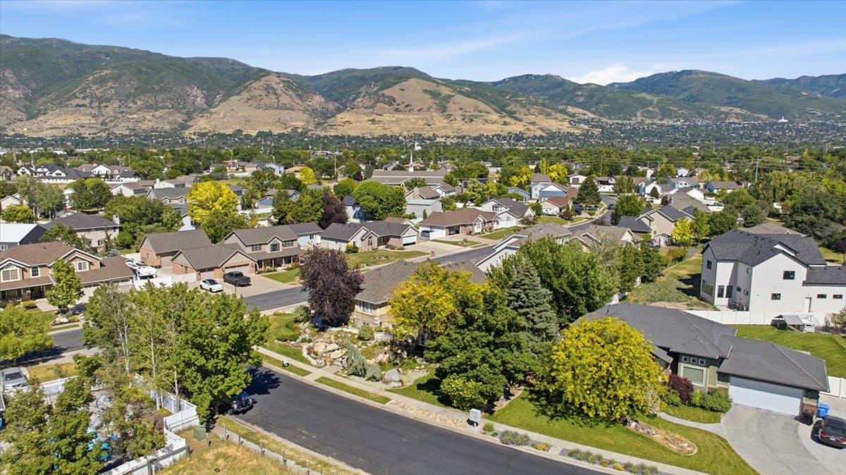 Residential neighborhood with mature landscaping and mountain backdrop