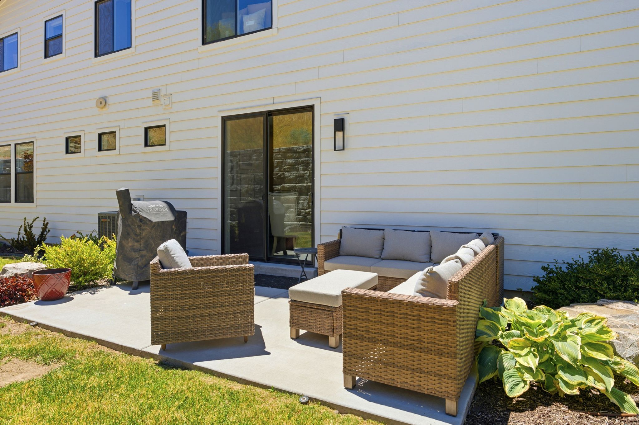 Outdoor patio featuring a concrete surface and a sliding glass door entry to the interior