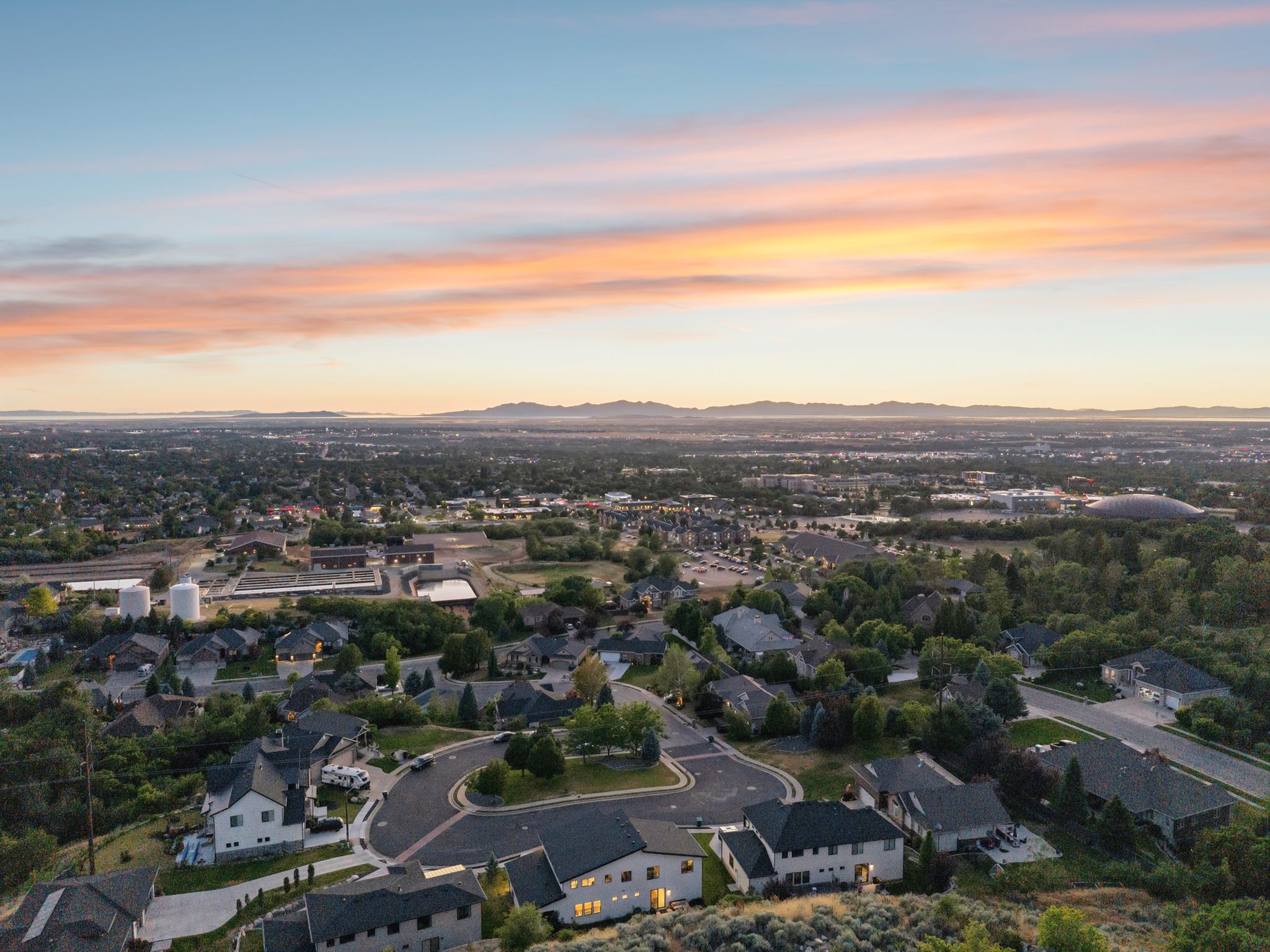 Aerial perspective showcasing a residential neighborhood with distant mountain ranges