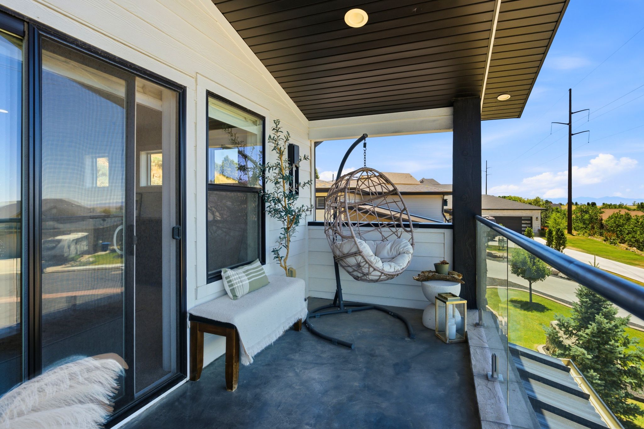 Covered balcony featuring a glass railing, dark-stained ceiling, and recessed lighting