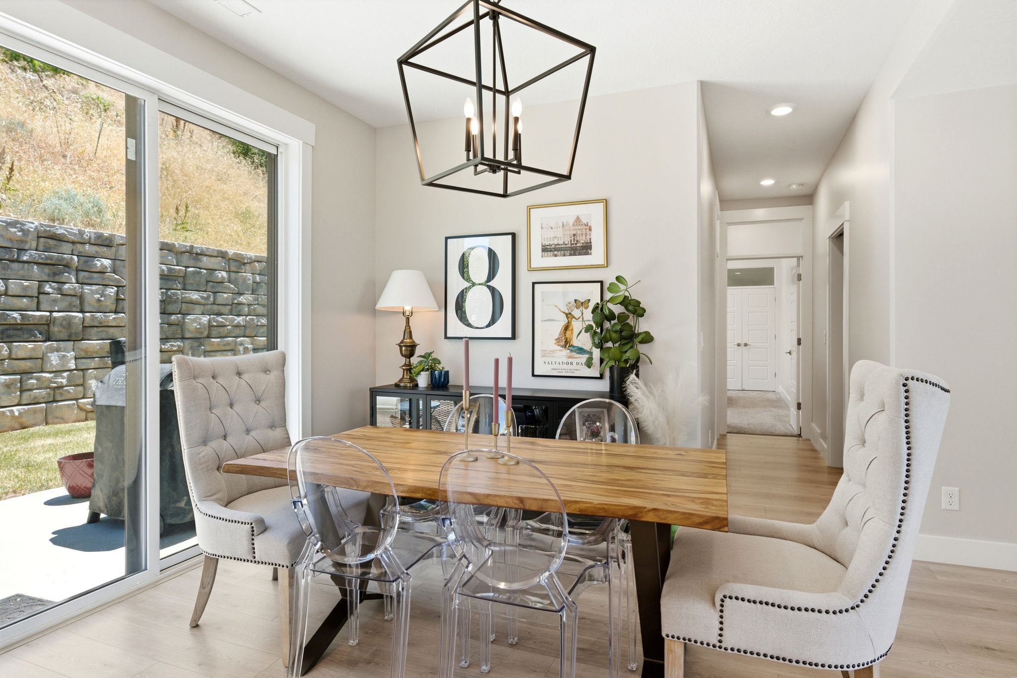 Dining area featuring a wood-finish table and contemporary chandelier