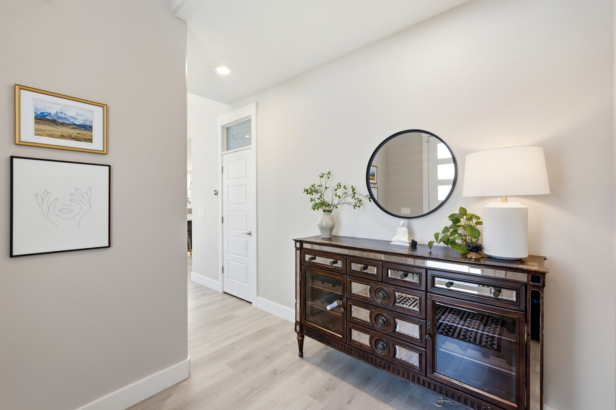 Hallway featuring light wood-finish flooring and recessed ceiling lighting