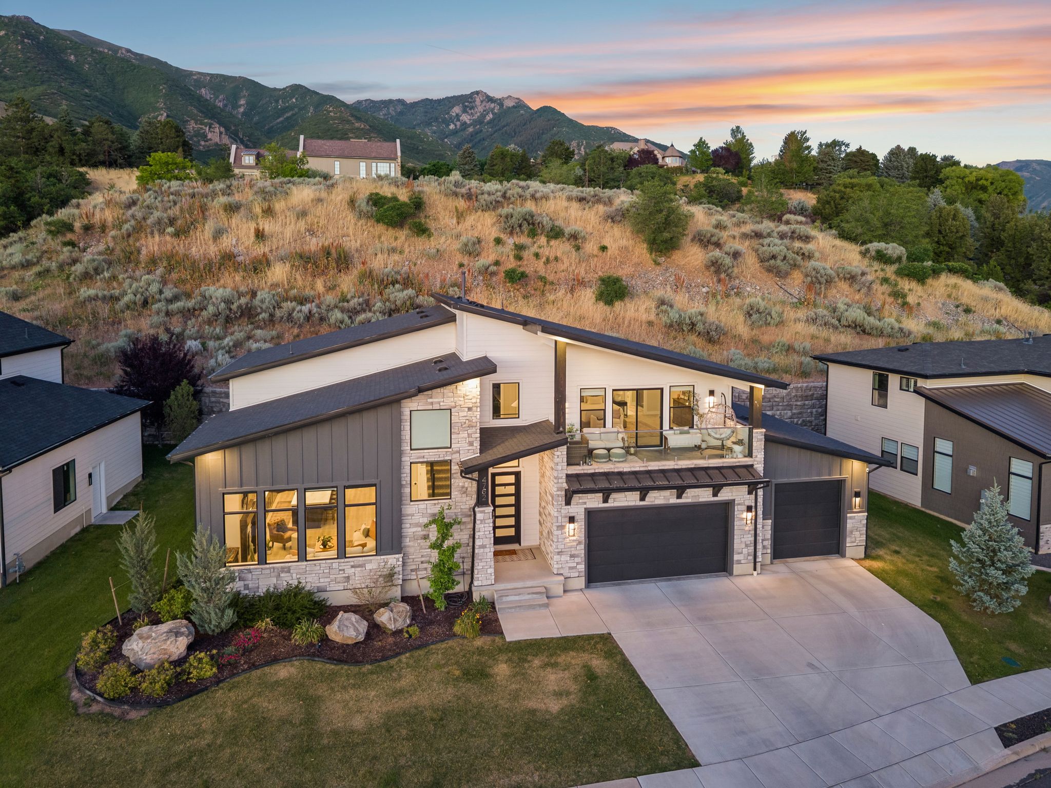 Modern architectural residence featuring a multi-level design and a concrete driveway