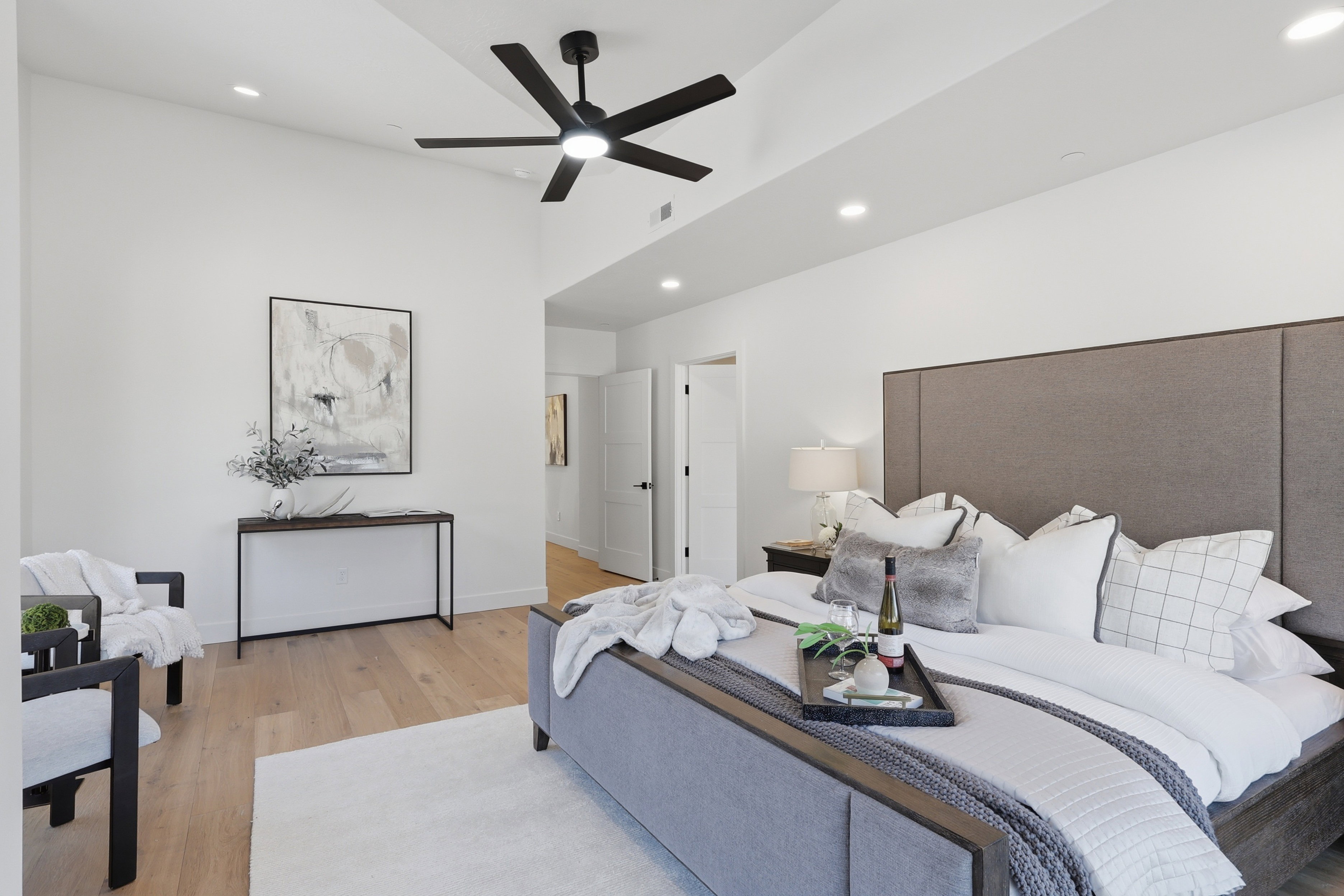 Spacious interior featuring a vaulted ceiling with a modern ceiling fan, recessed lighting, and wood-finish flooring