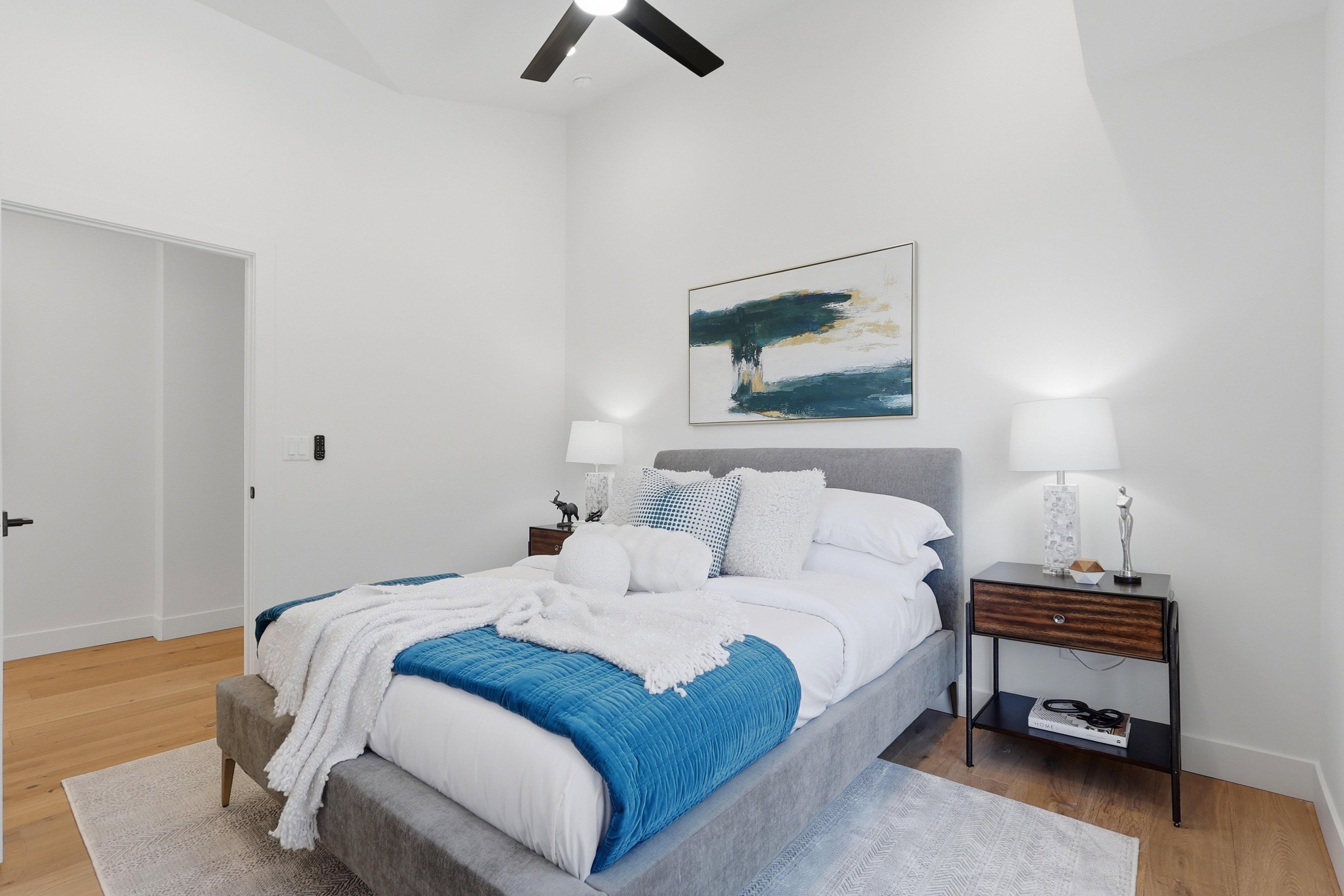 Light wood-finish flooring complements the crisp white walls and vaulted ceiling