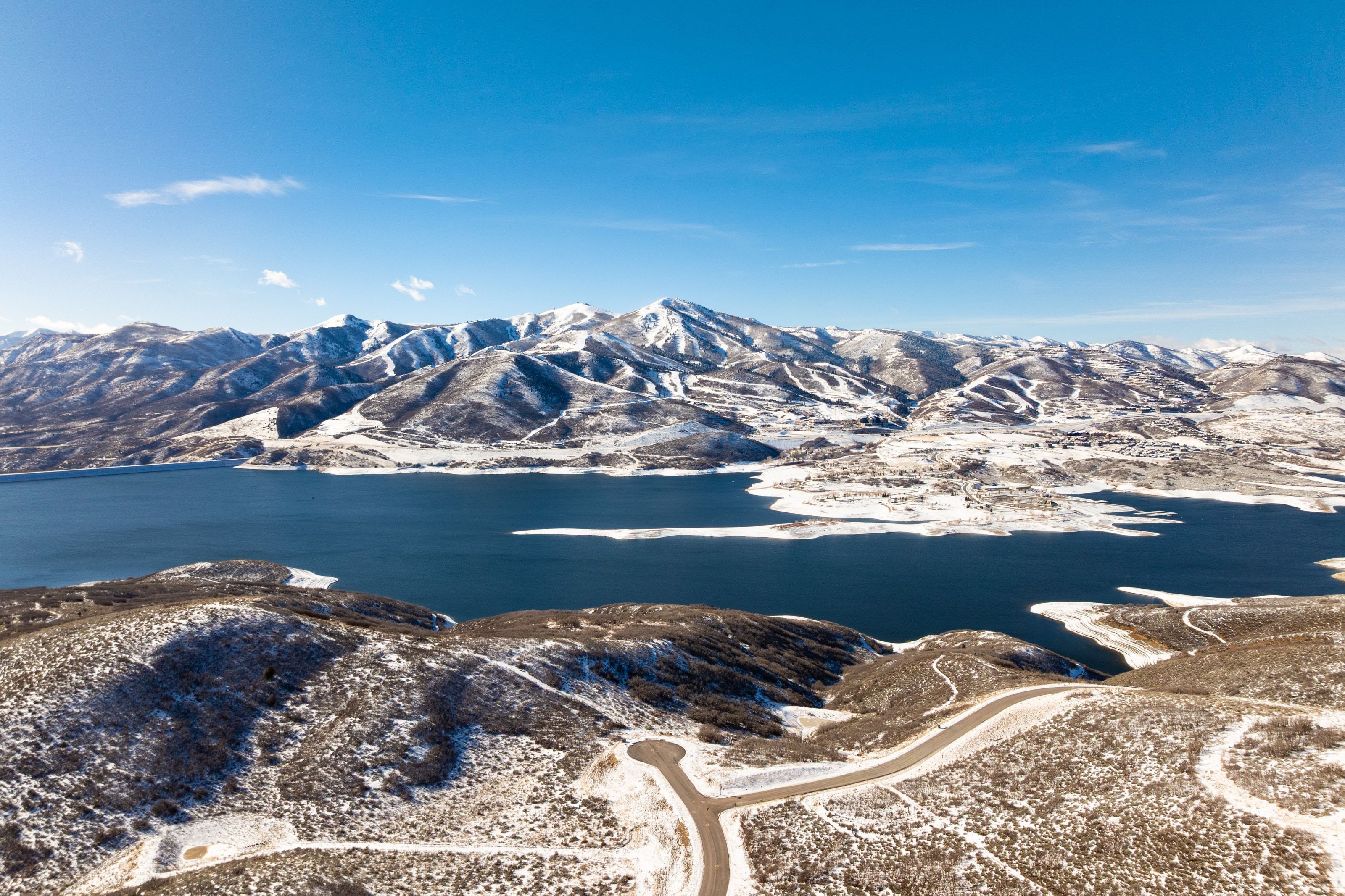 Expansive water body framed by snow-dusted mountains