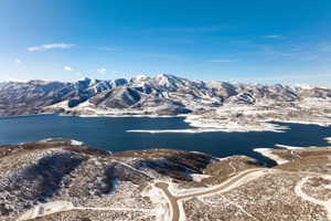 Expansive water body framed by snow-dusted mountains