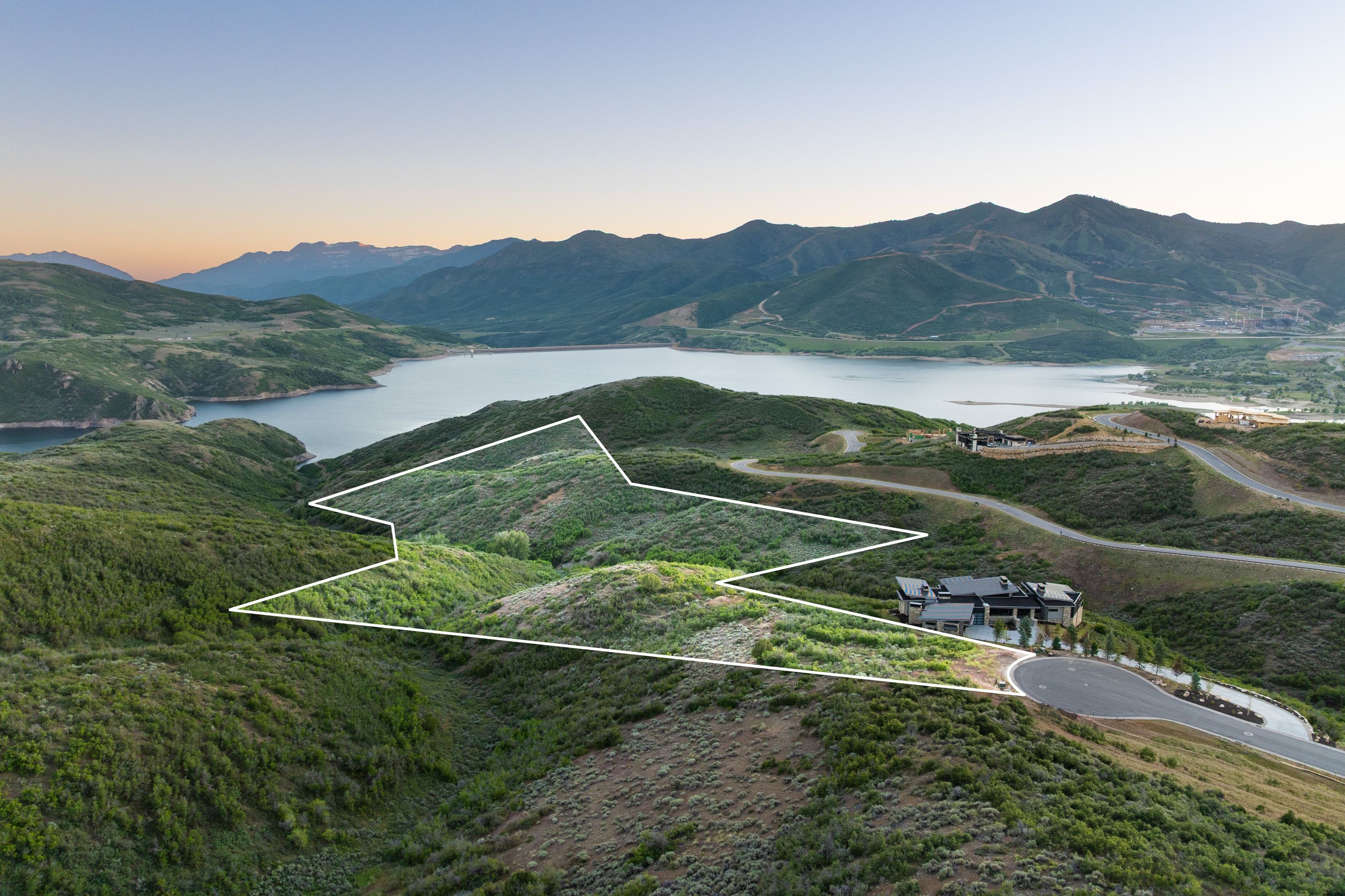 Expansive land parcel outlined, featuring varied green topography