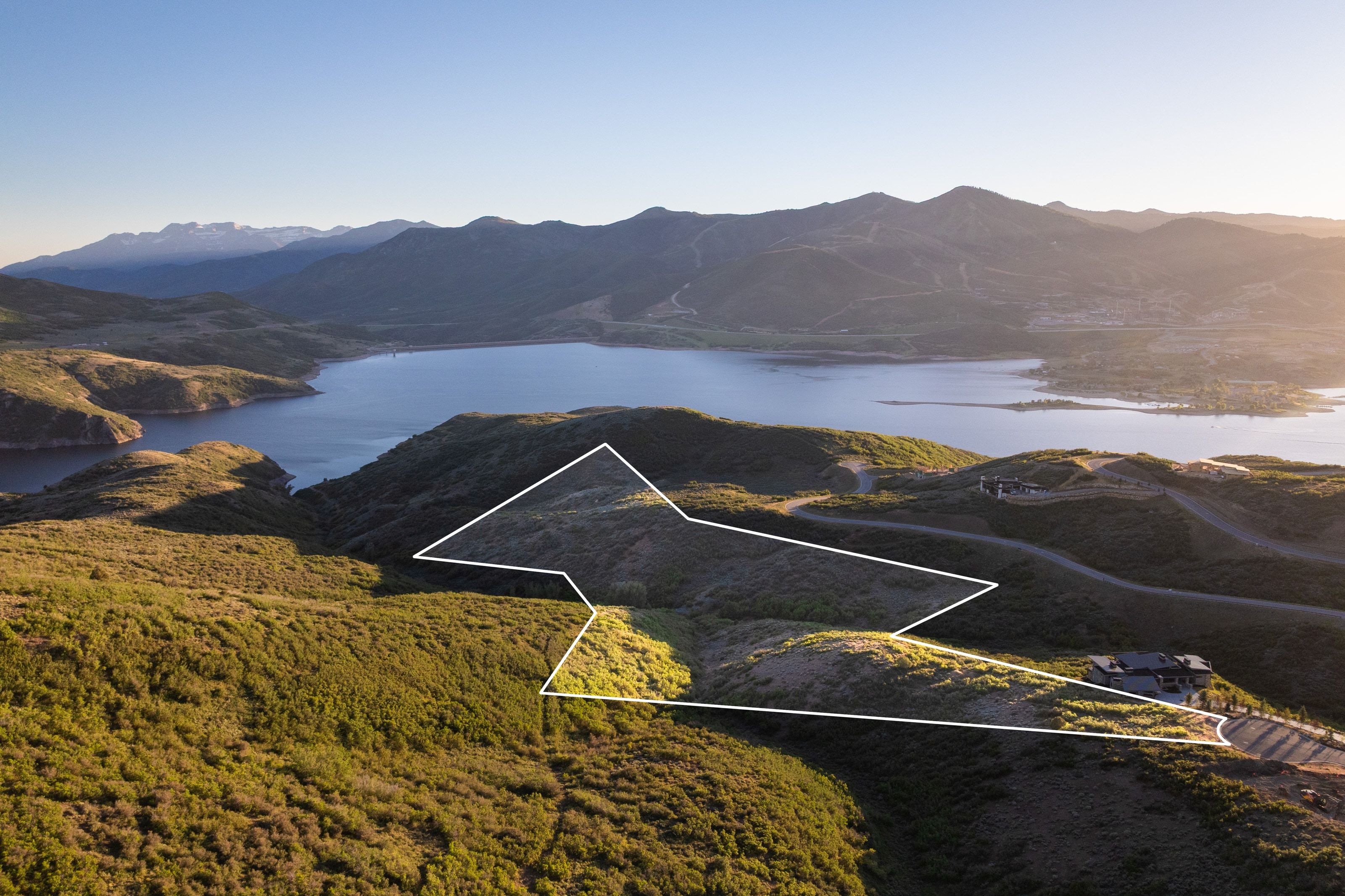 Expansive land parcel outlined in white, featuring natural terrain and lush green vegetation