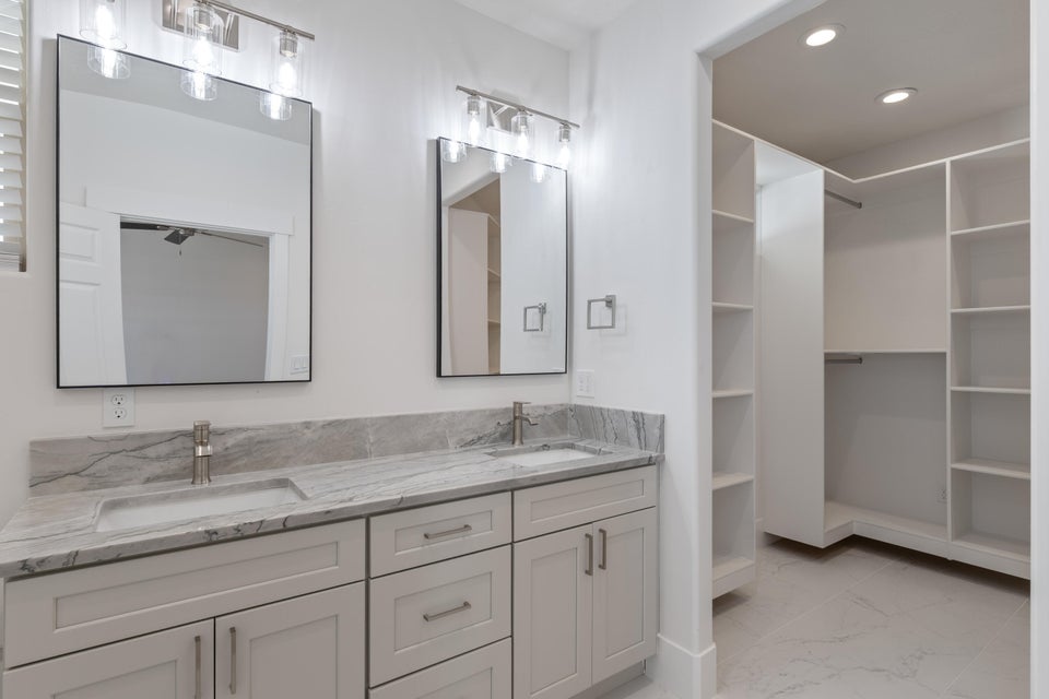 Dual vanity with square undermount sinks, gray veined countertop, and brushed nickel faucets