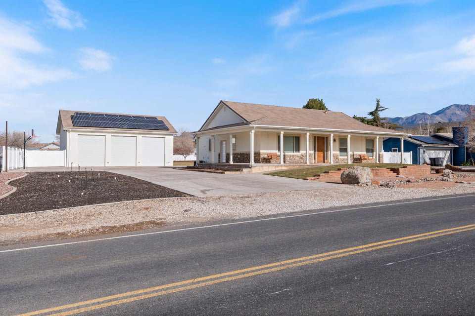 Ranch-style exterior with a covered front porch and stone accents