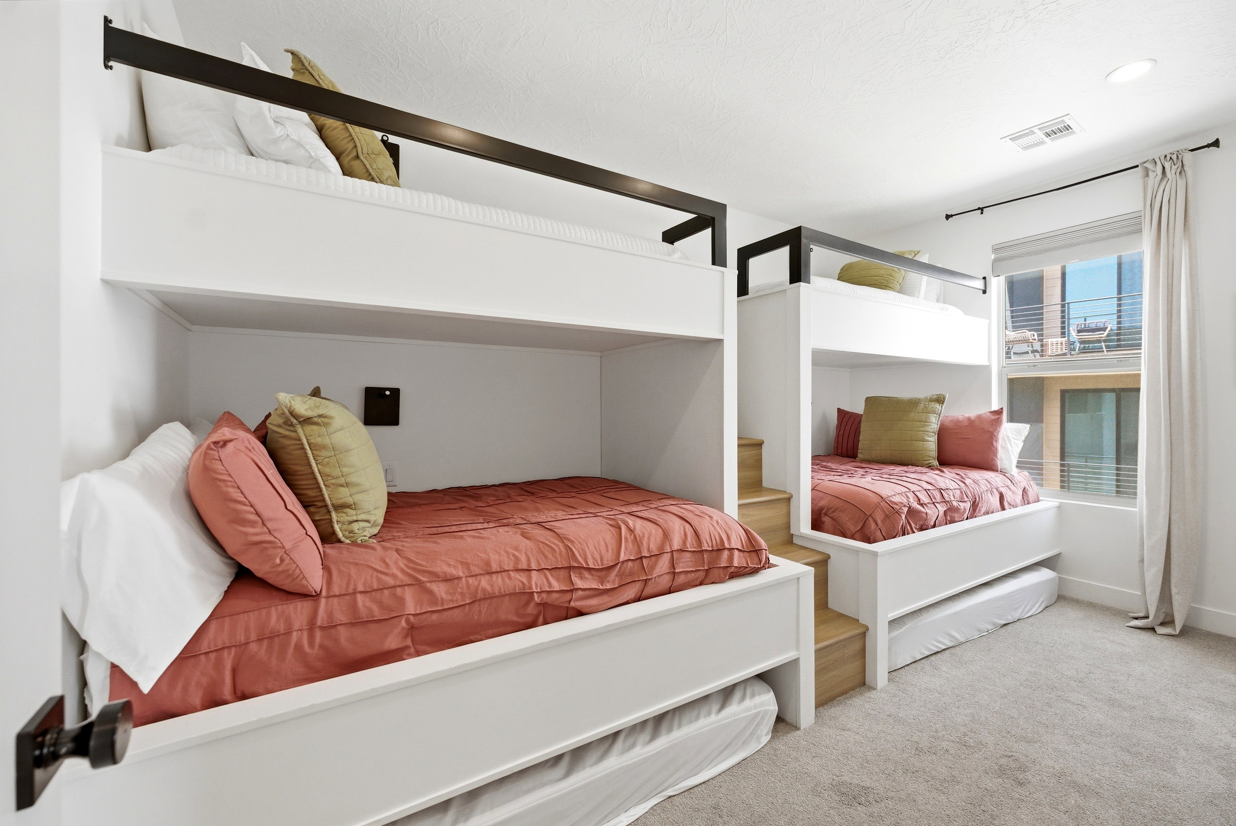 Room featuring built-in bunk beds with integrated wooden steps