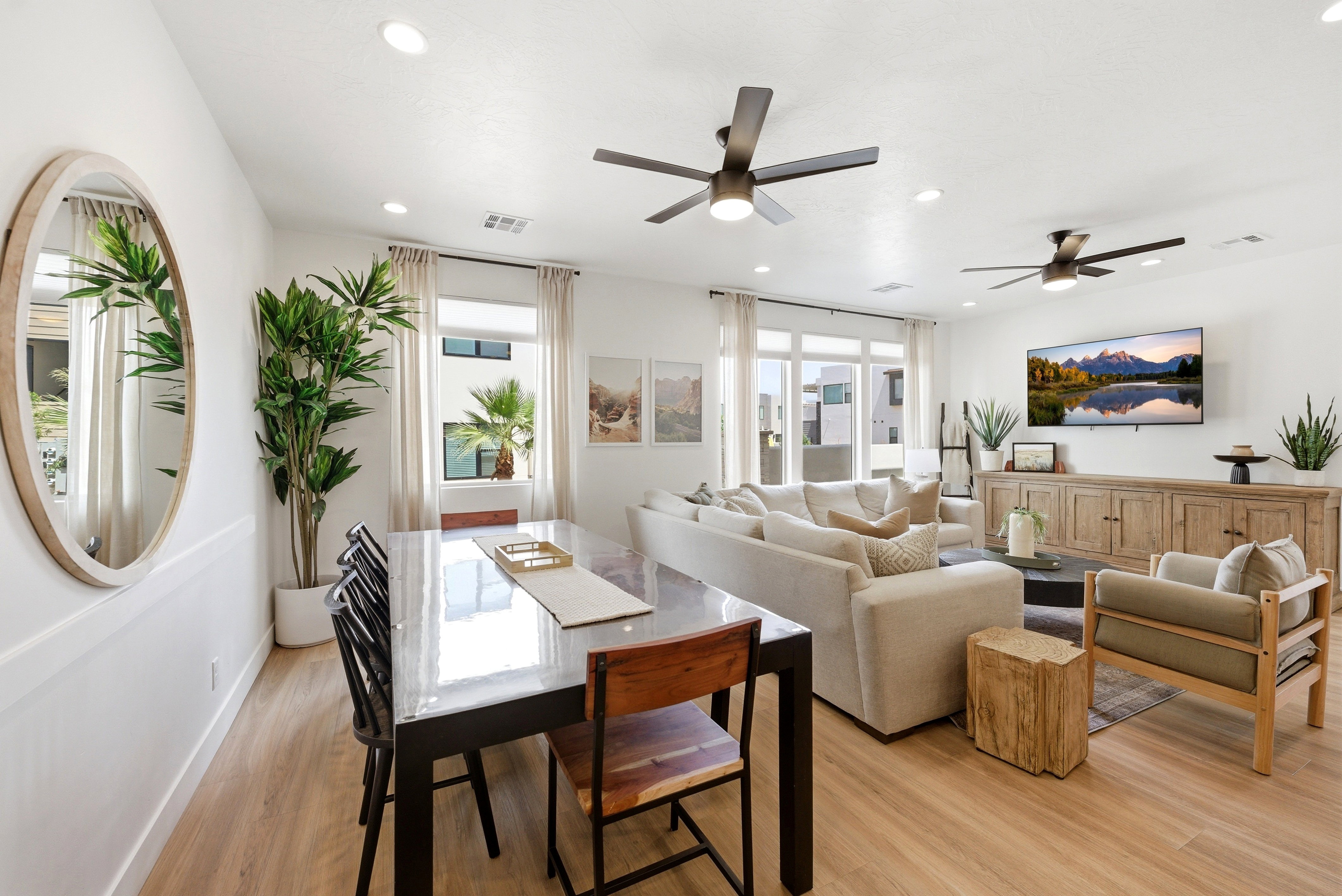 Open-concept living space featuring wood-finish flooring, recessed lighting, and white walls
