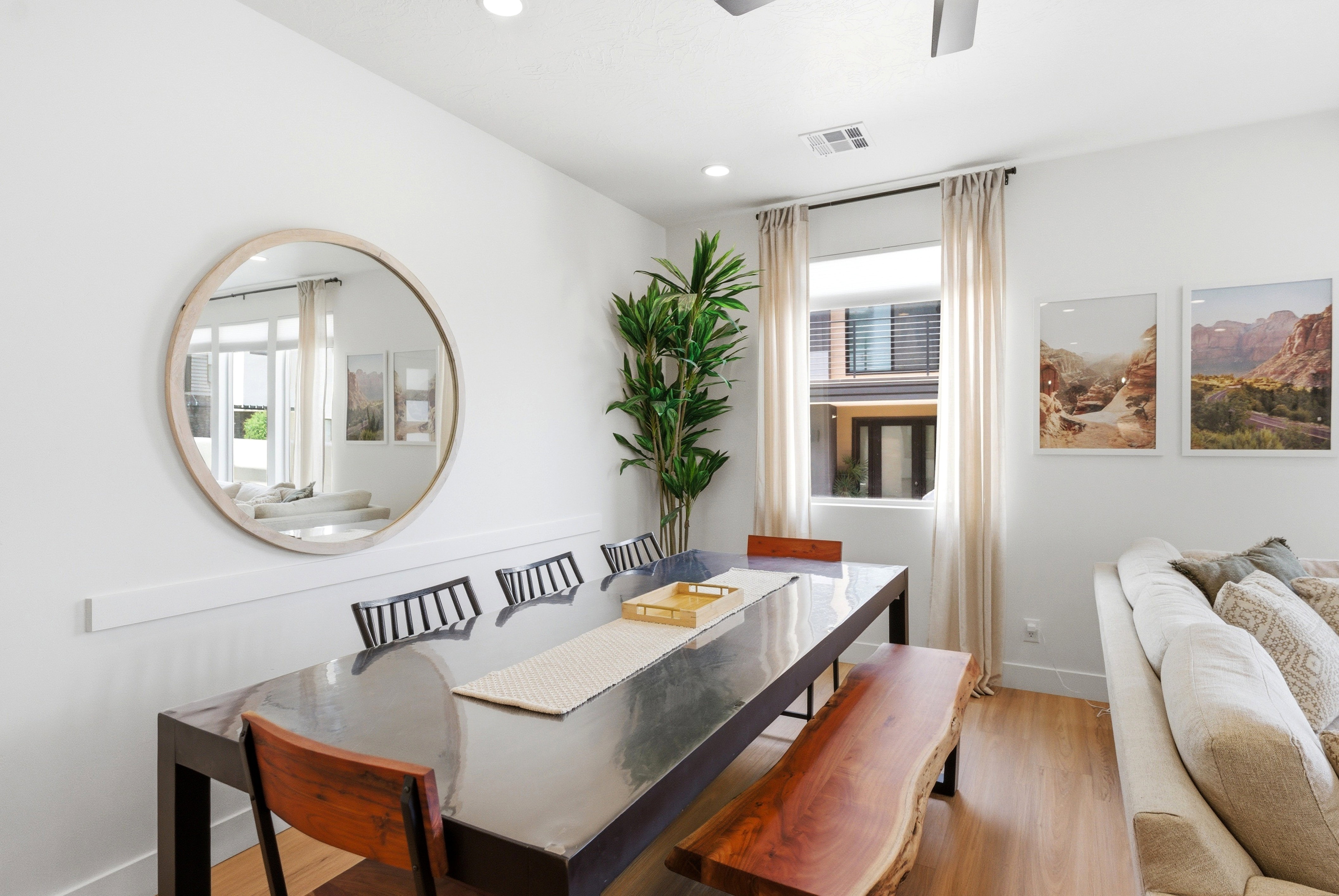 Bright dining area featuring wood-finish flooring and a contemporary ceiling fan