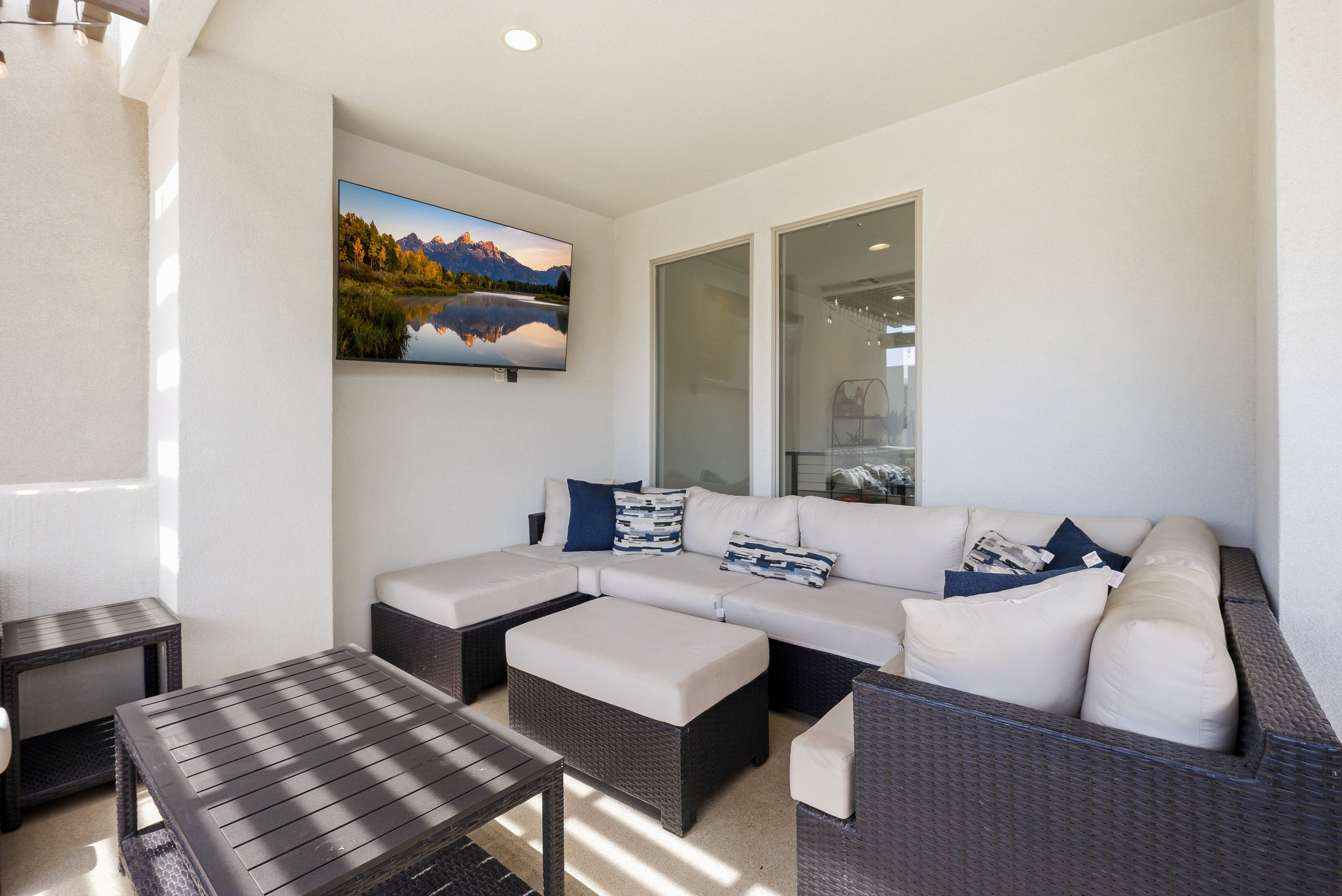 Covered patio featuring a ceiling-mounted television