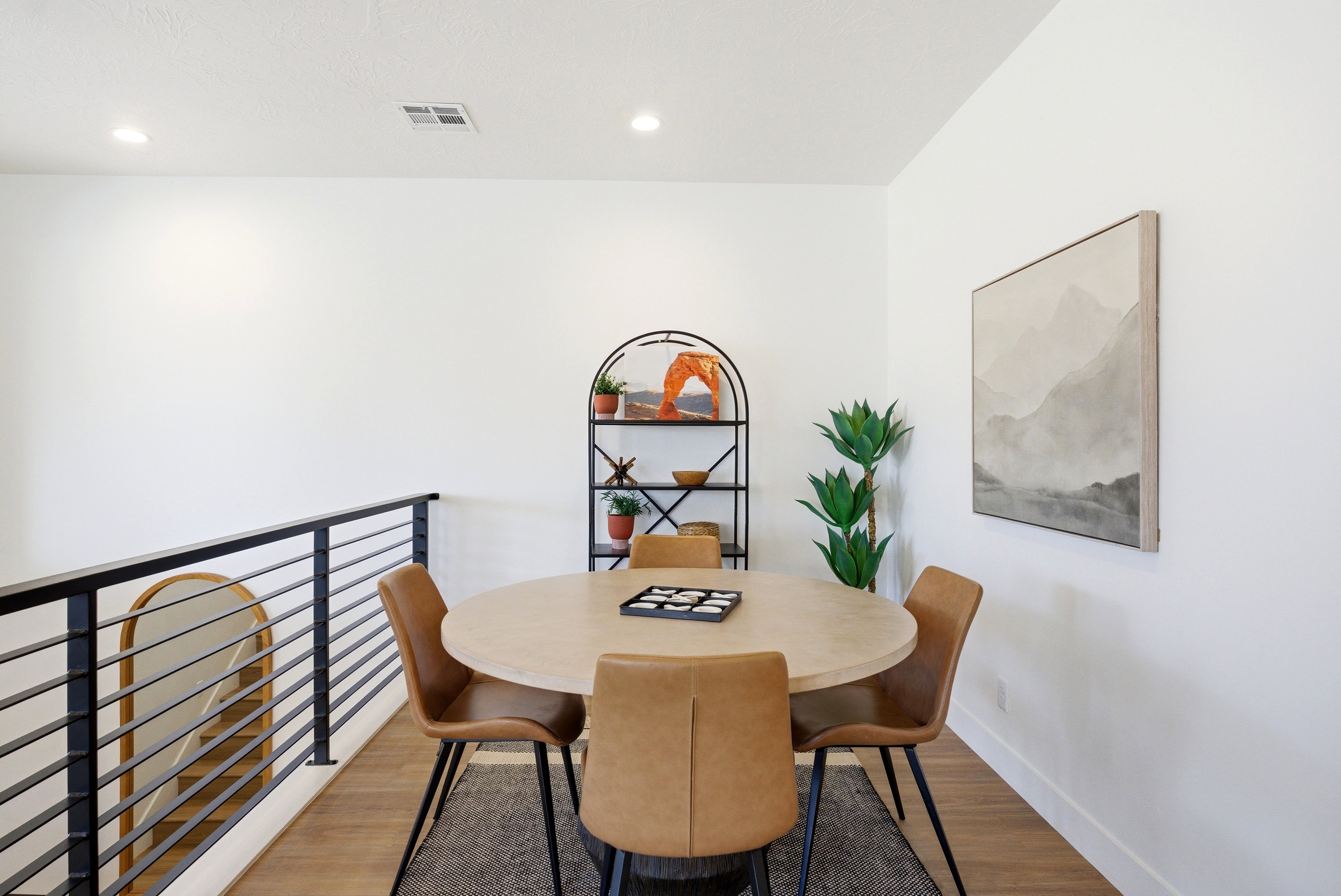 Upper-level room featuring recessed lighting, a modern horizontal bar railing, and wood-finish flooring