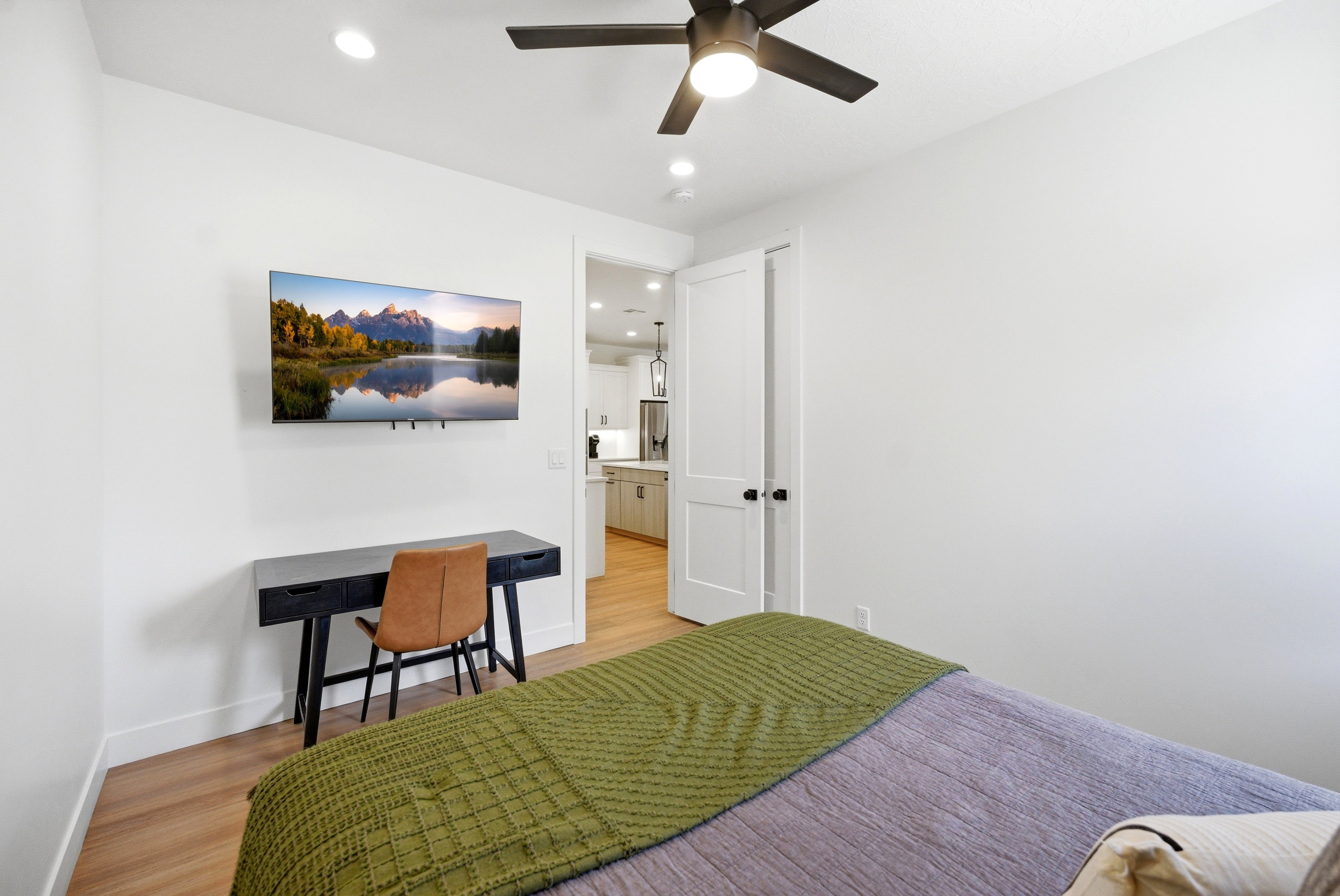 Room featuring wood-finish flooring, recessed lighting, and a dark-toned ceiling fan