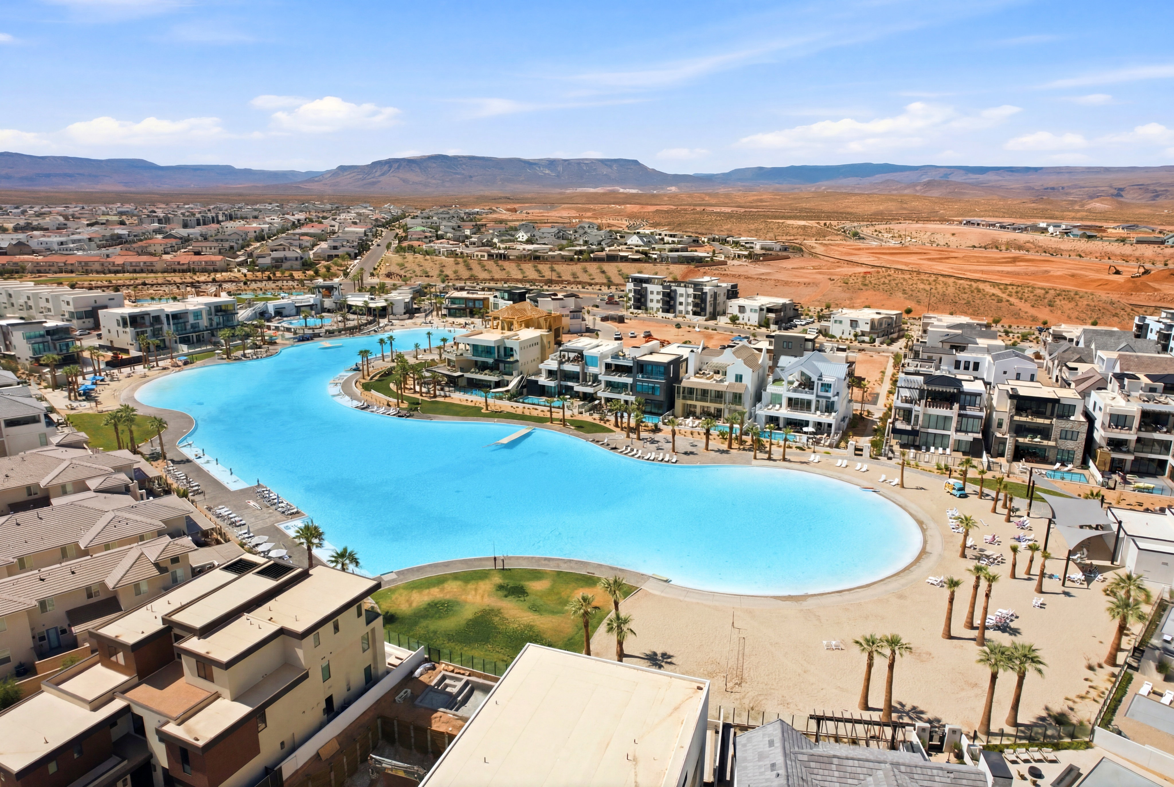 Expansive residential development featuring a large artificial lagoon with sandy beaches