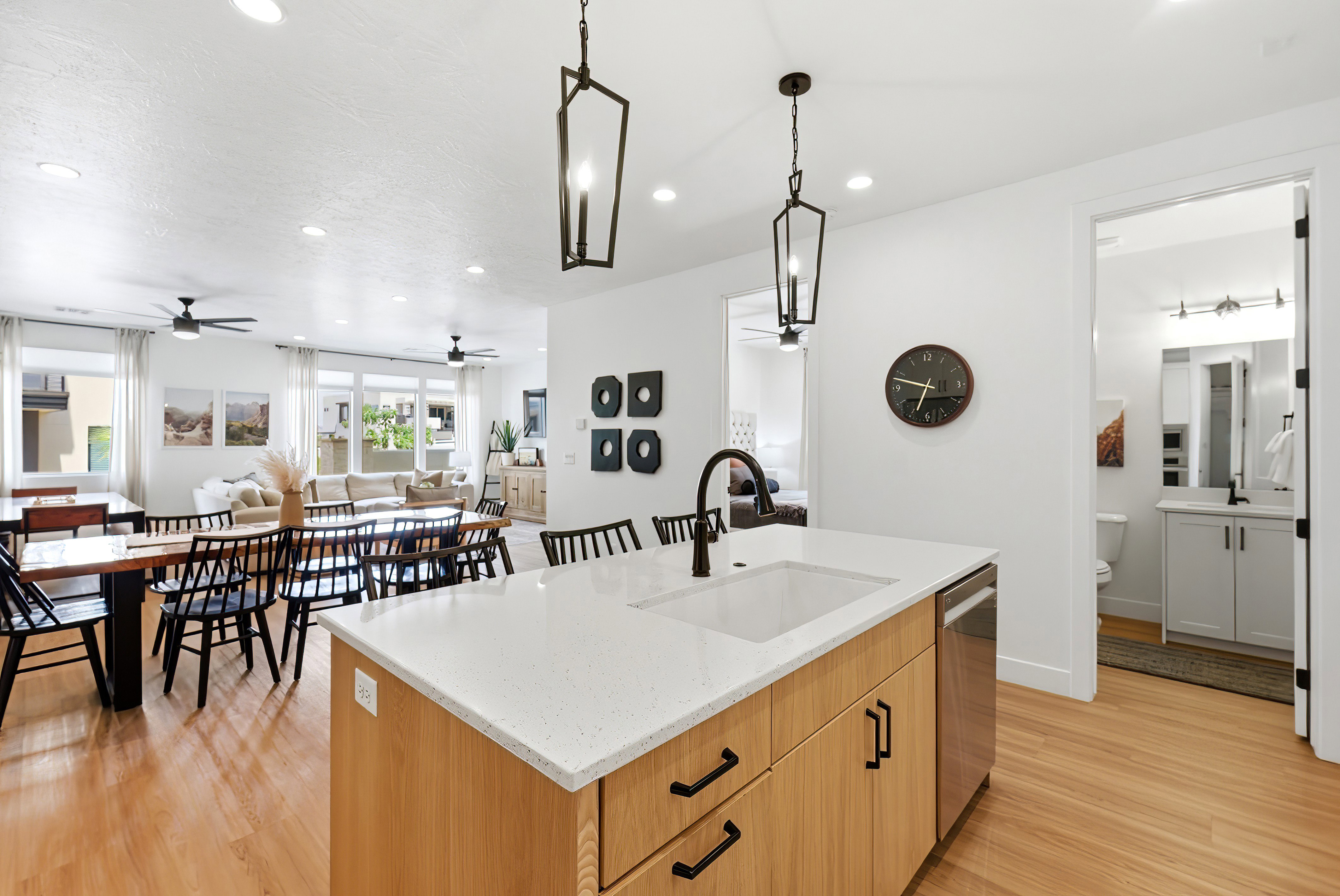 Contemporary kitchen island with a white solid surface countertop, integrated sink, and matte black faucet
