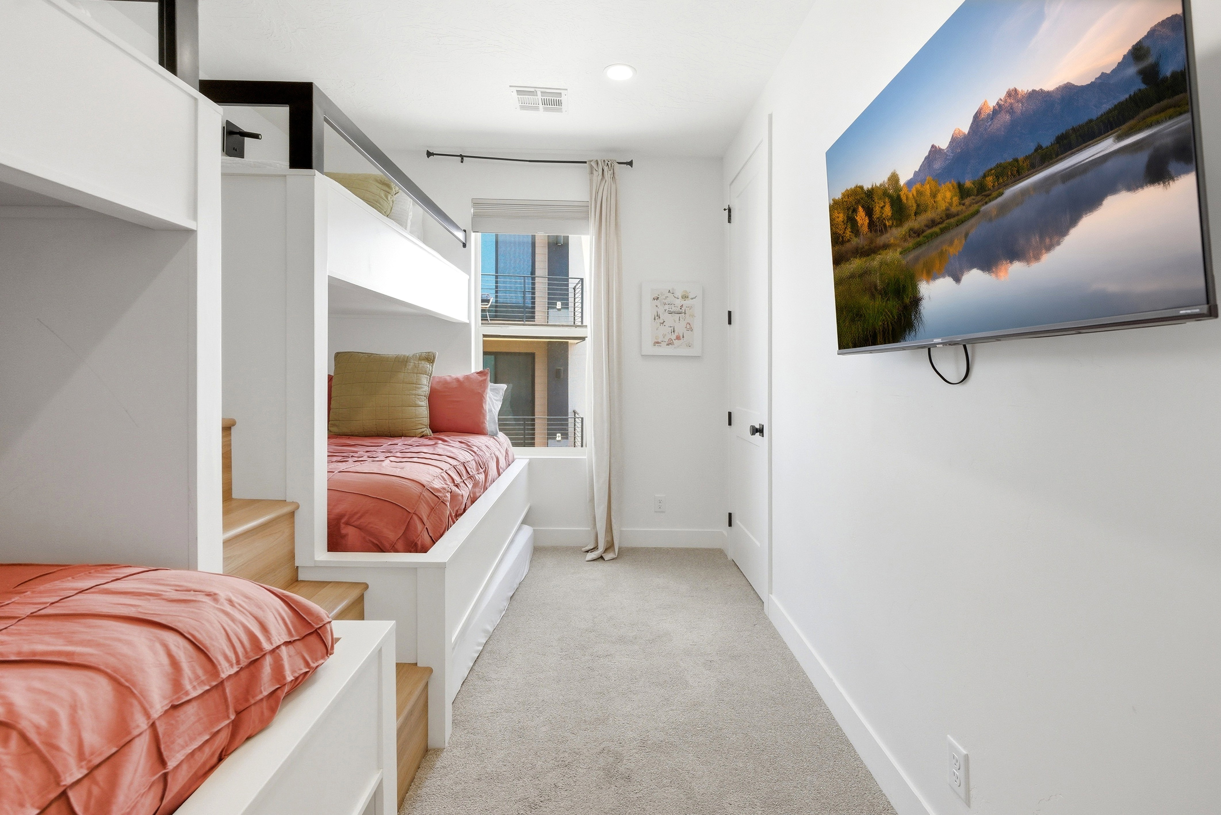Built-in bunk beds with integrated wood-finish steps and pull-out storage drawers