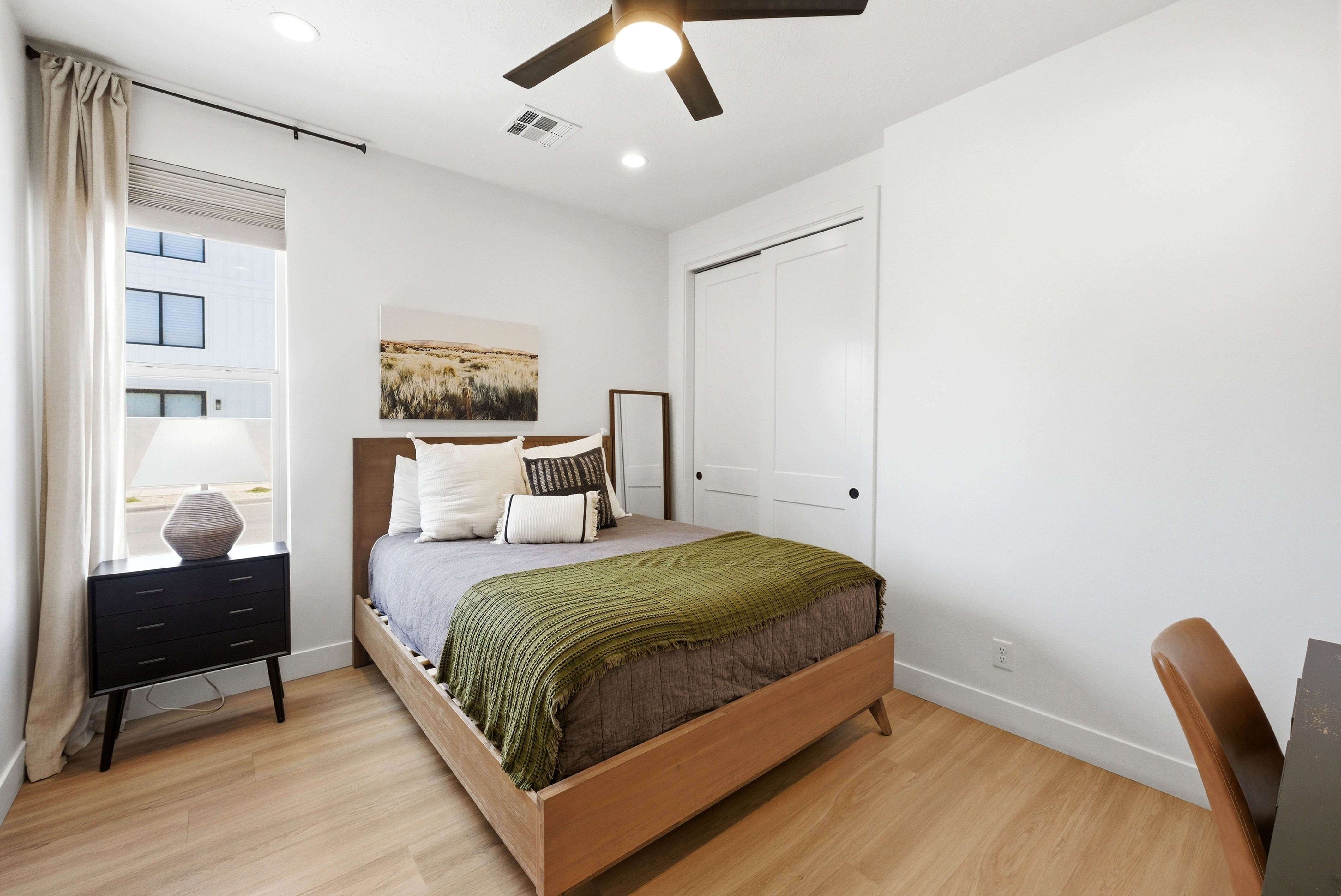 Light wood-finish flooring complements the bright white walls of this space