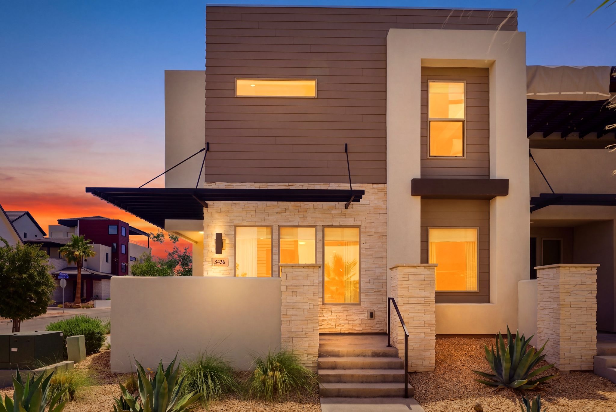 Contemporary multi-story exterior with stacked stone accents and horizontal siding