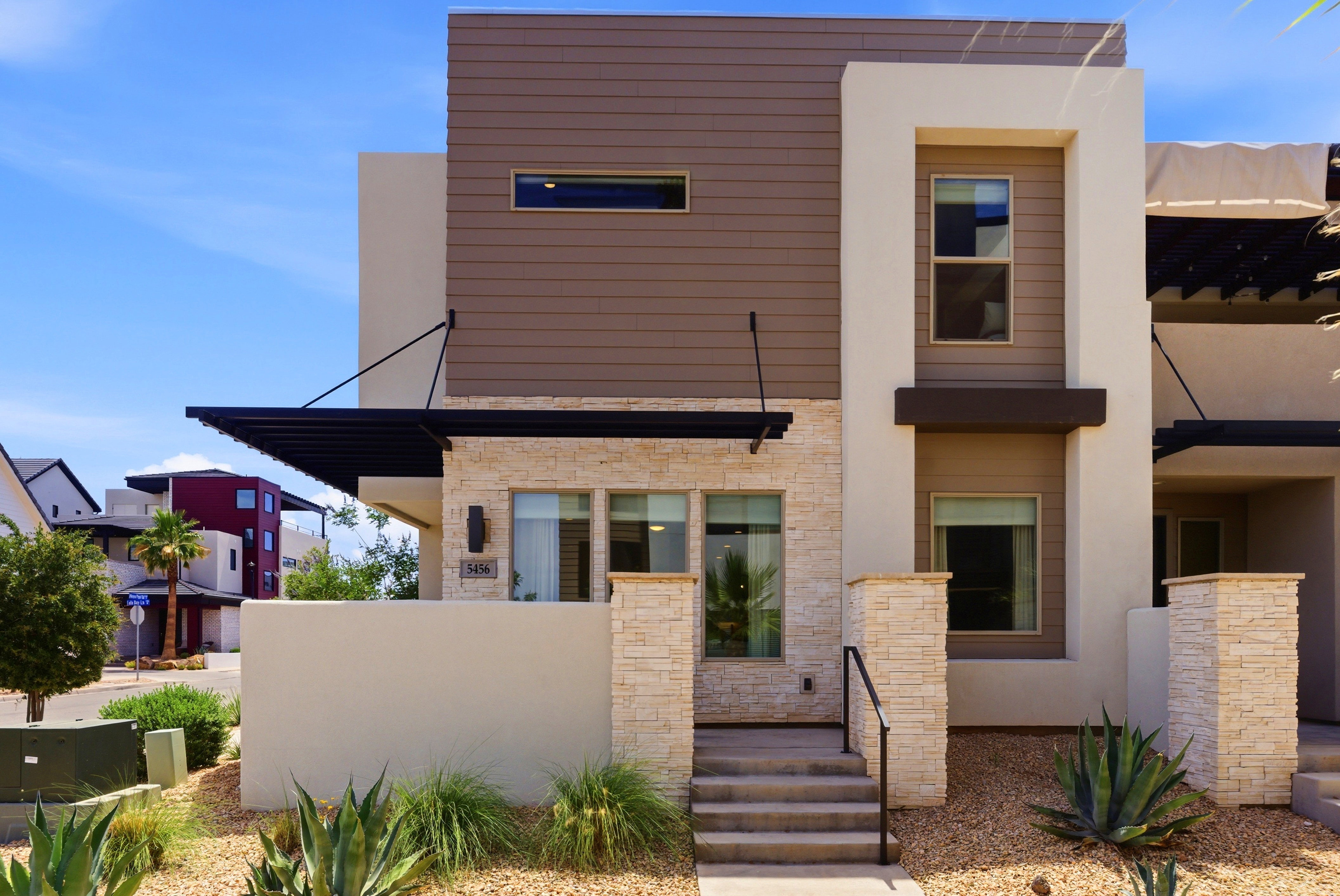 Contemporary exterior featuring horizontal siding, stone veneer, and stucco finishes