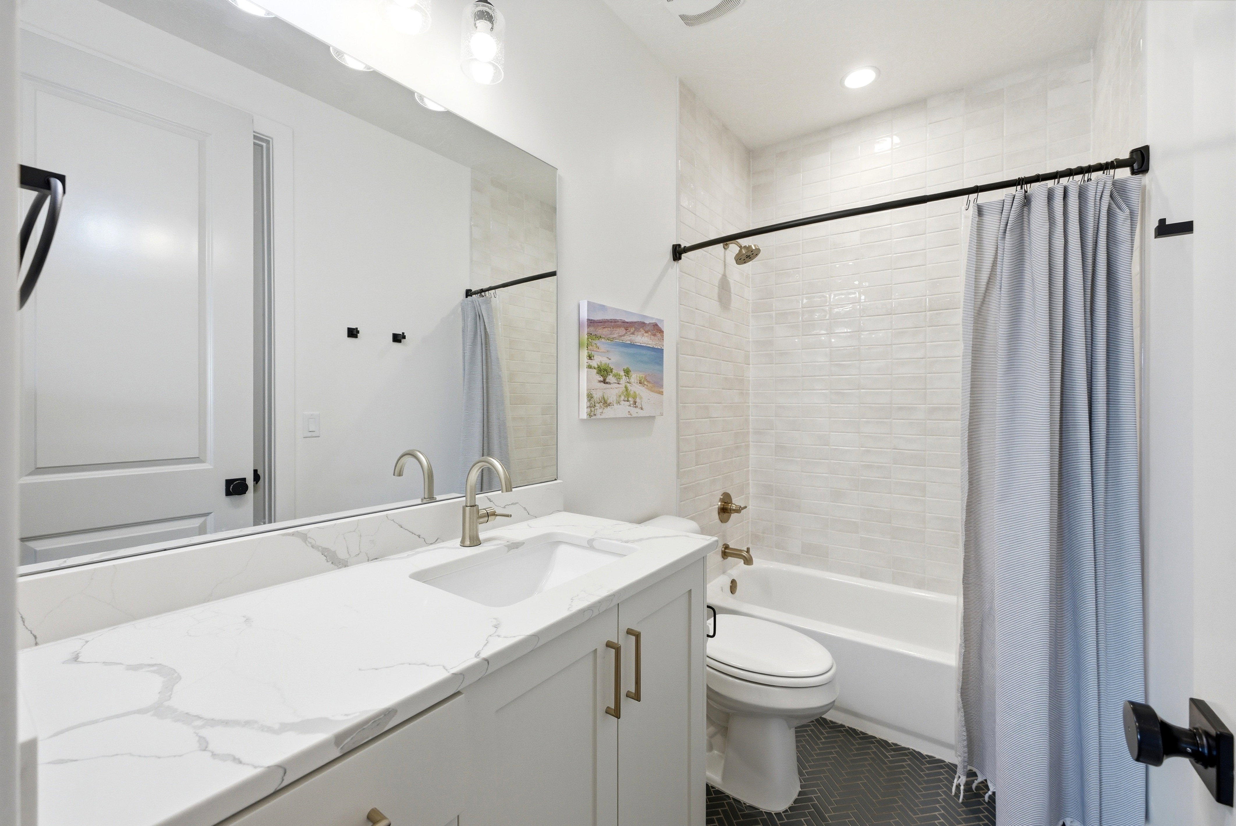 Bathroom featuring a single vanity with a white countertop and undermount sink