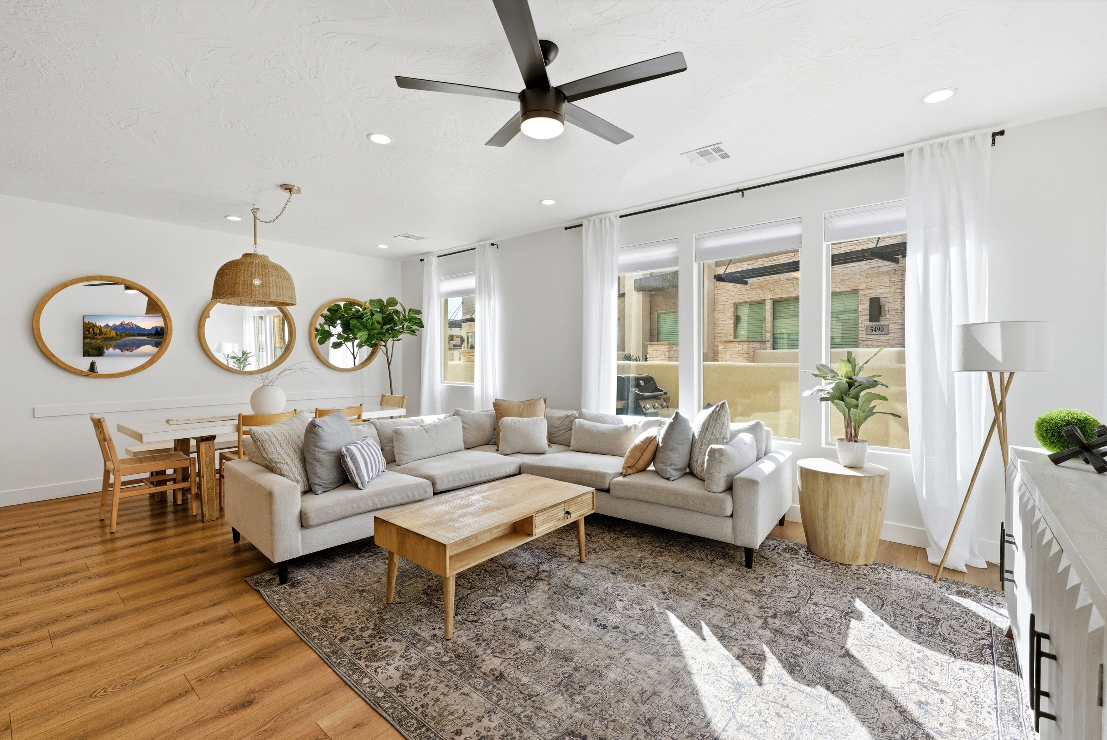 Open-concept living space featuring wood-finish flooring, recessed lighting, and a contemporary ceiling fan