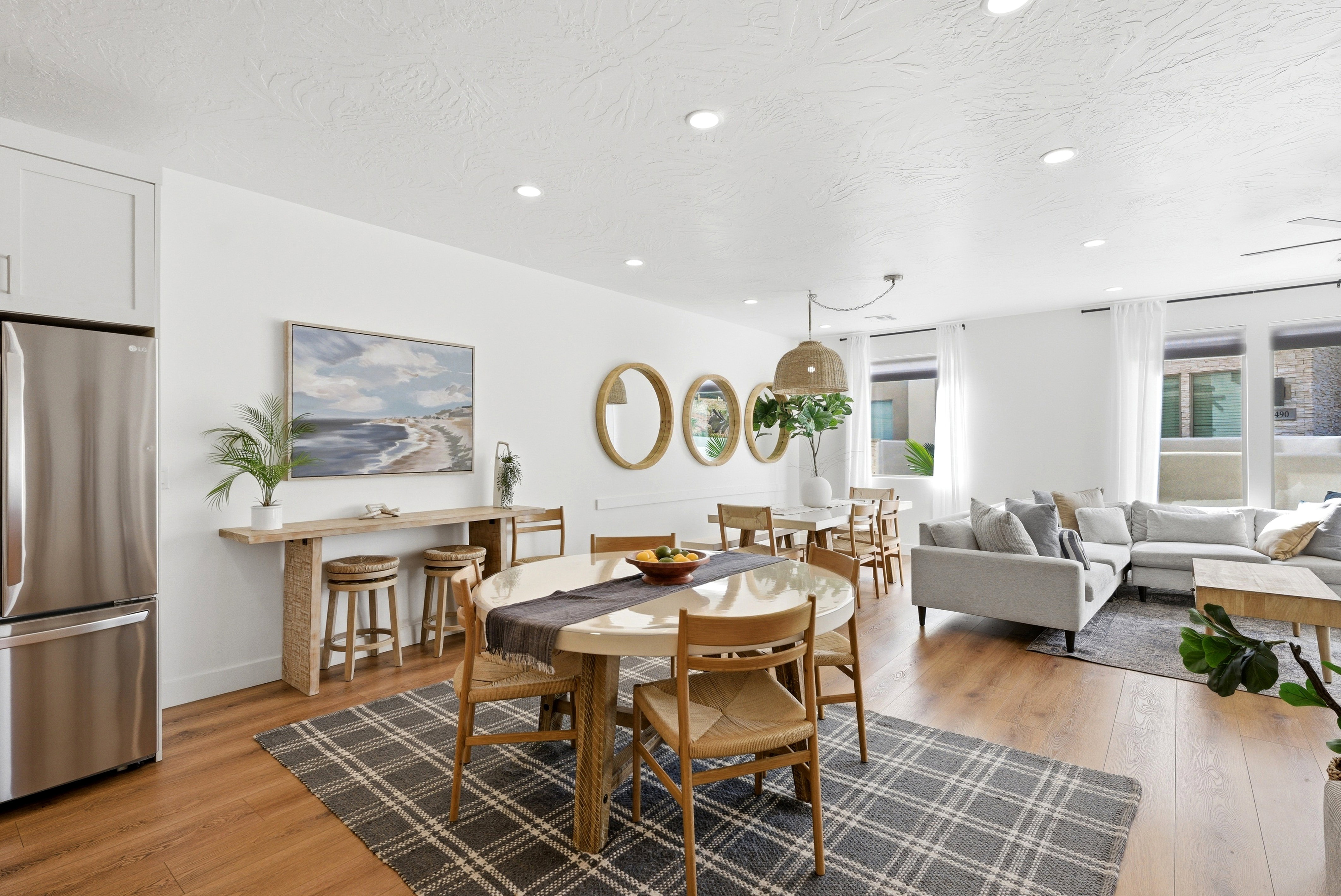 Open-concept living space featuring wood-finish flooring, recessed lighting, and white walls